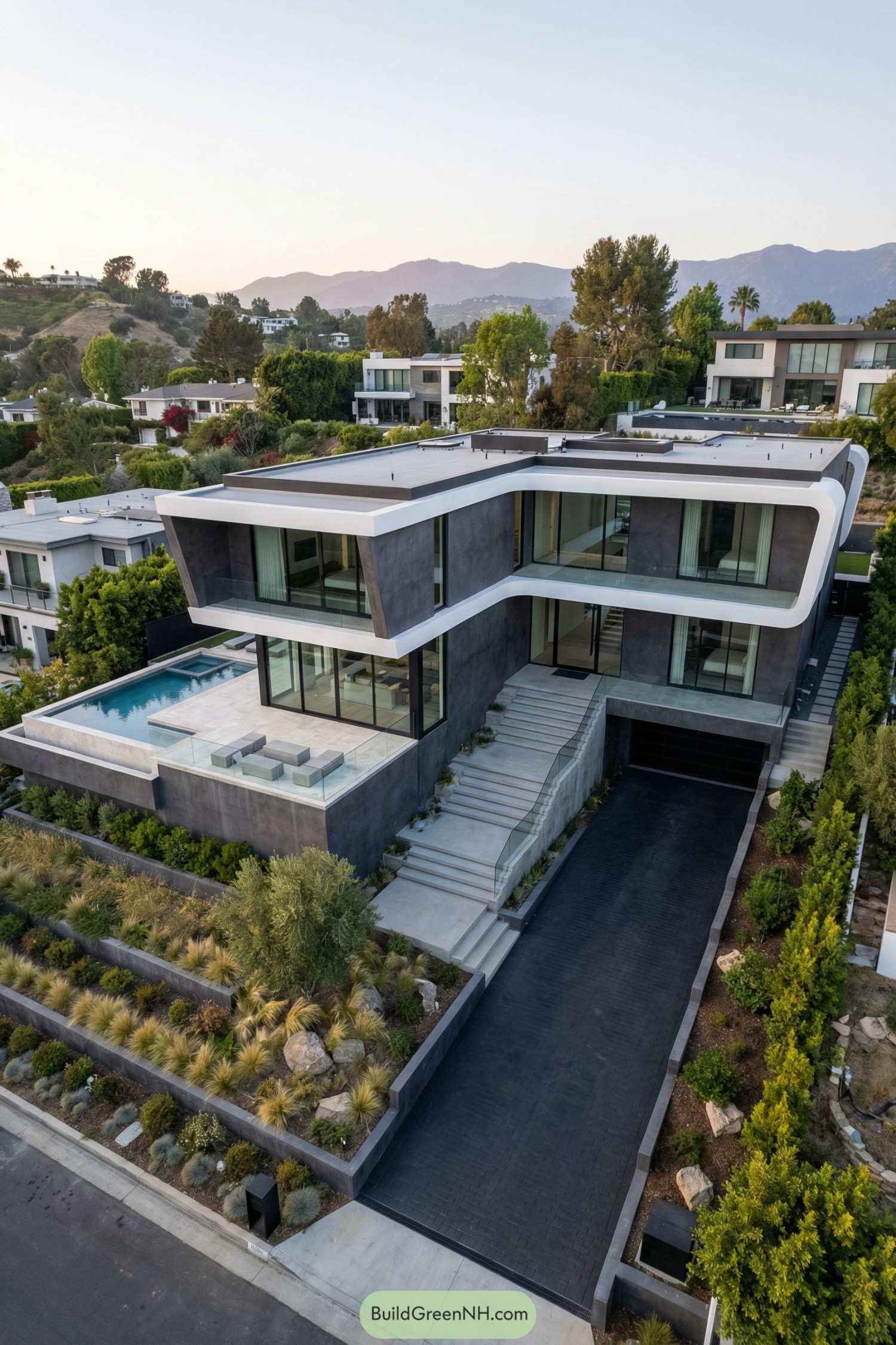 Minimalist multi level hillside home with cantilevered glass volumes and a pool terrace