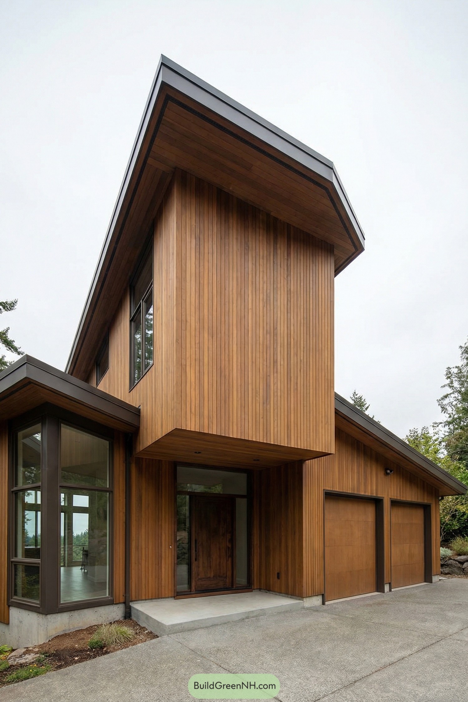 Tall wood clad modern house with dramatic overhanging roof and large windows