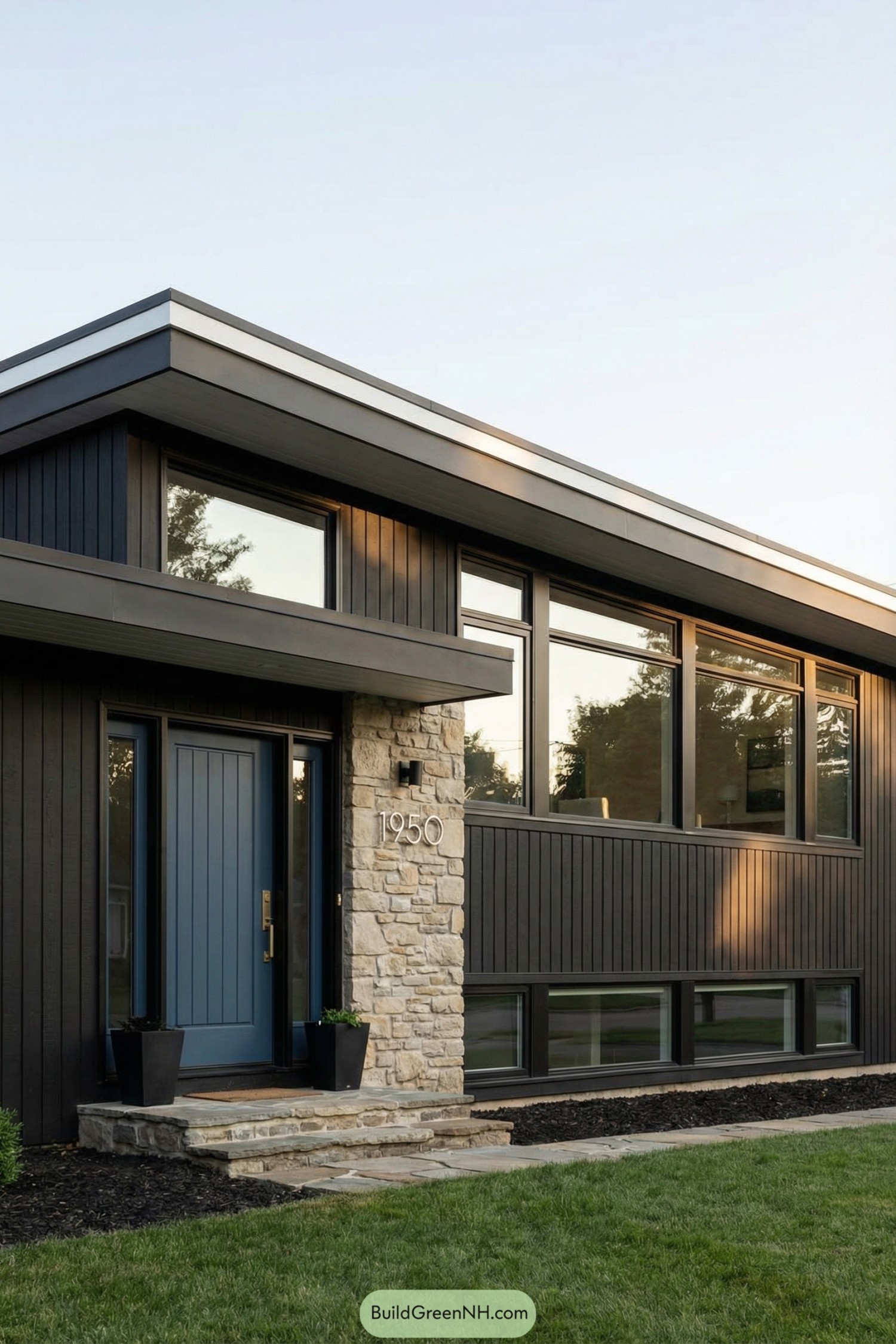 Black mid century home with stone entry column and long strip of windows