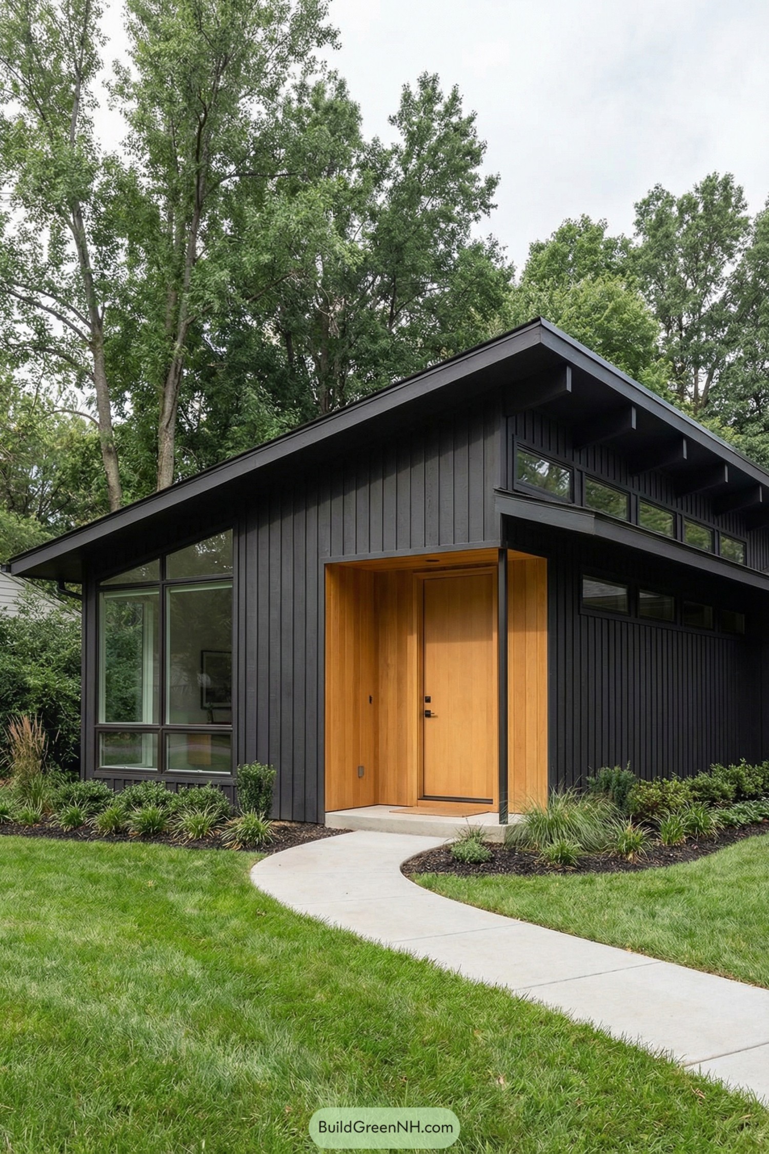 Black vertical siding mid century house with warm wood entry and large corner window