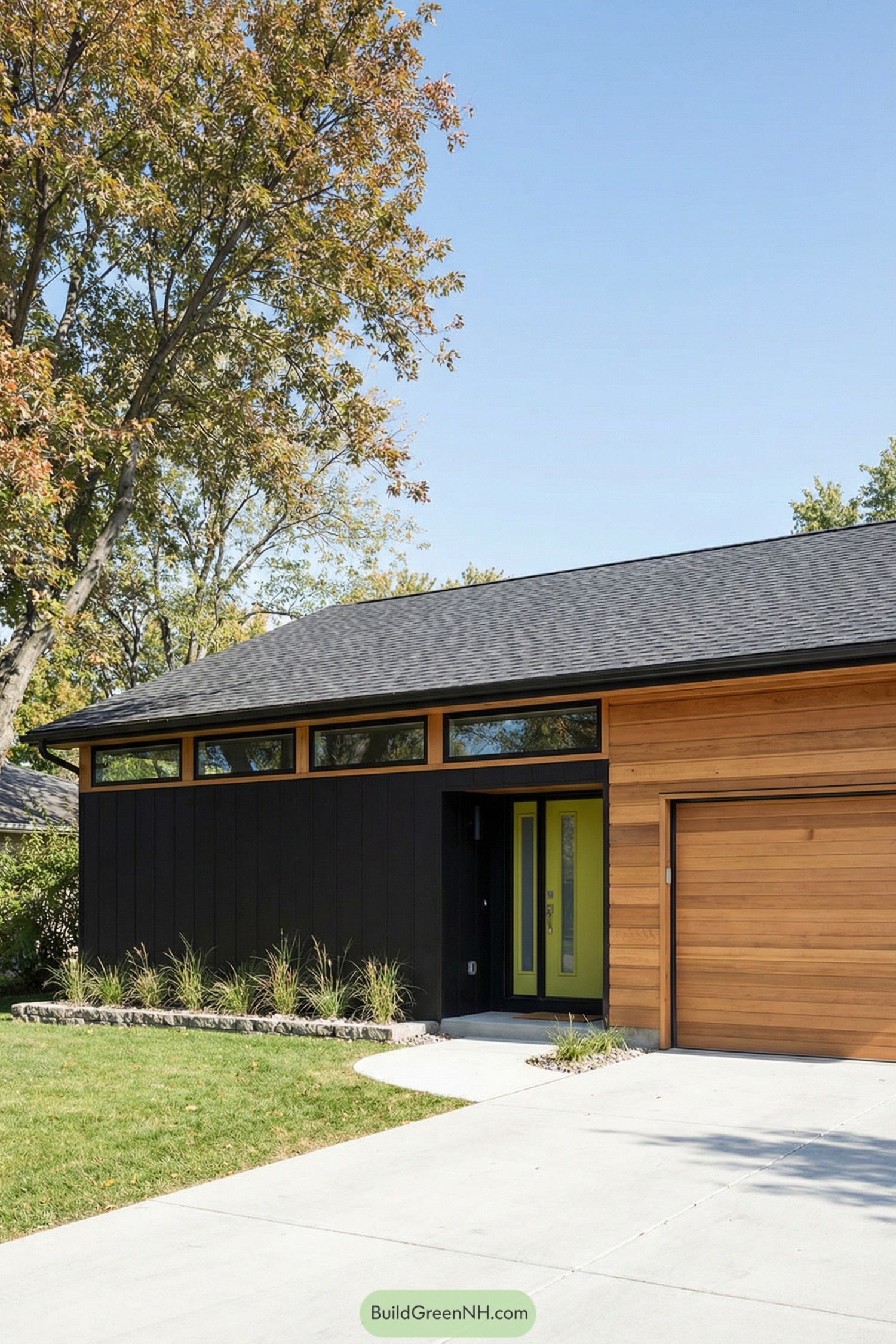 Single story black and wood house with bright green entry door and slim clerestory windows