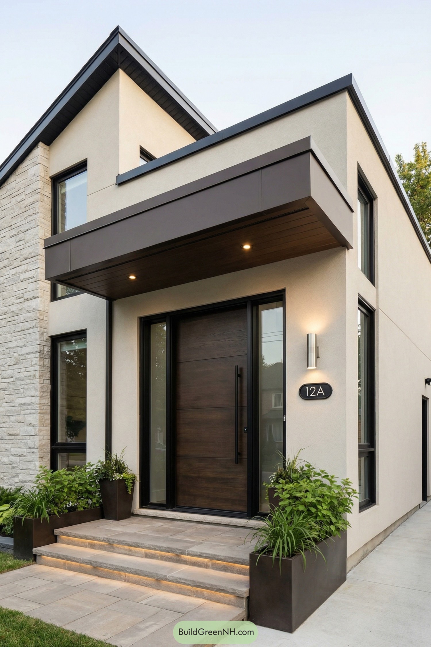 Modern front entry with wide wood door under sleek overhang and flanking planters