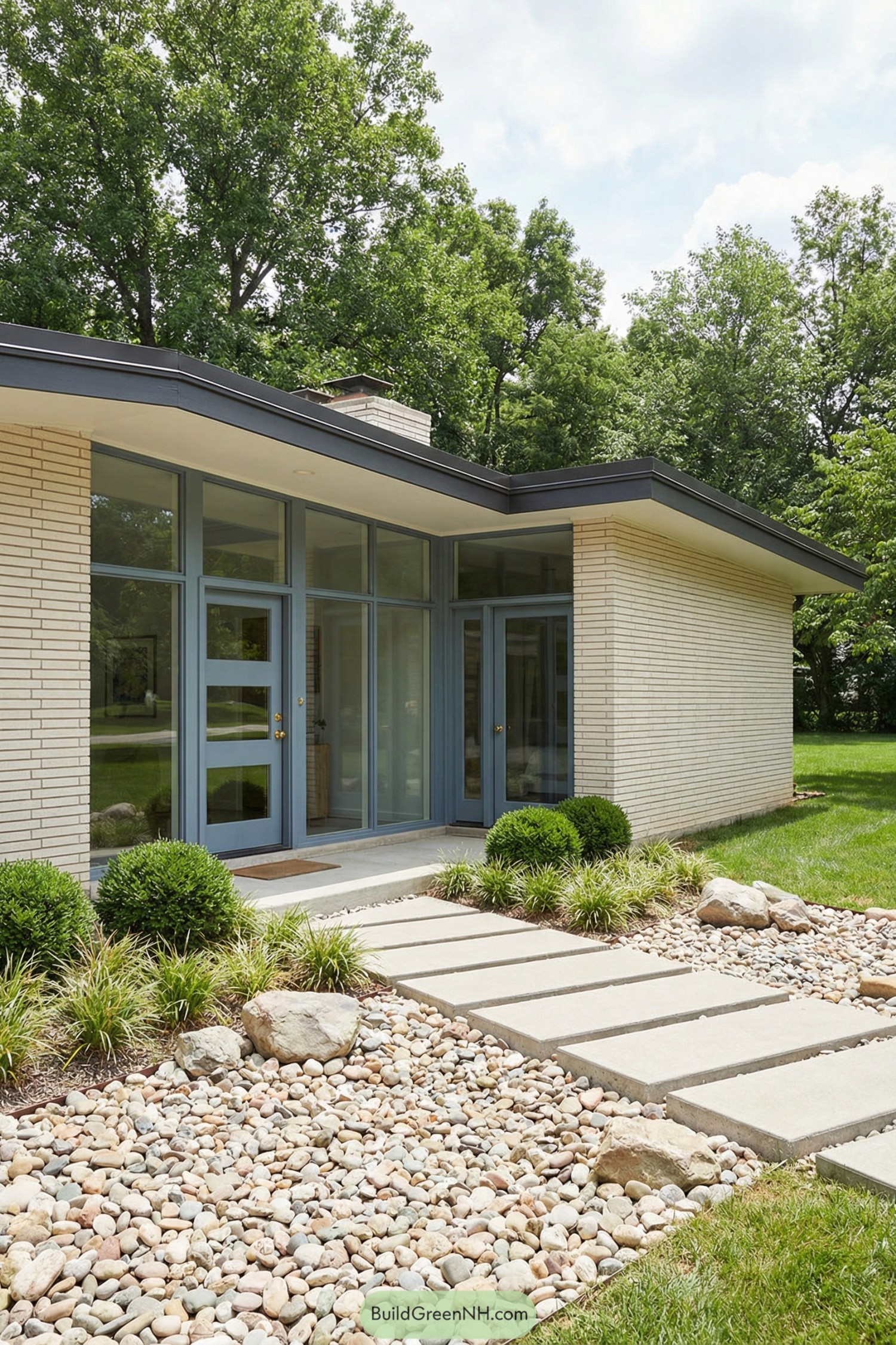 Midcentury ranch entry with blue-framed glass and stone walkway