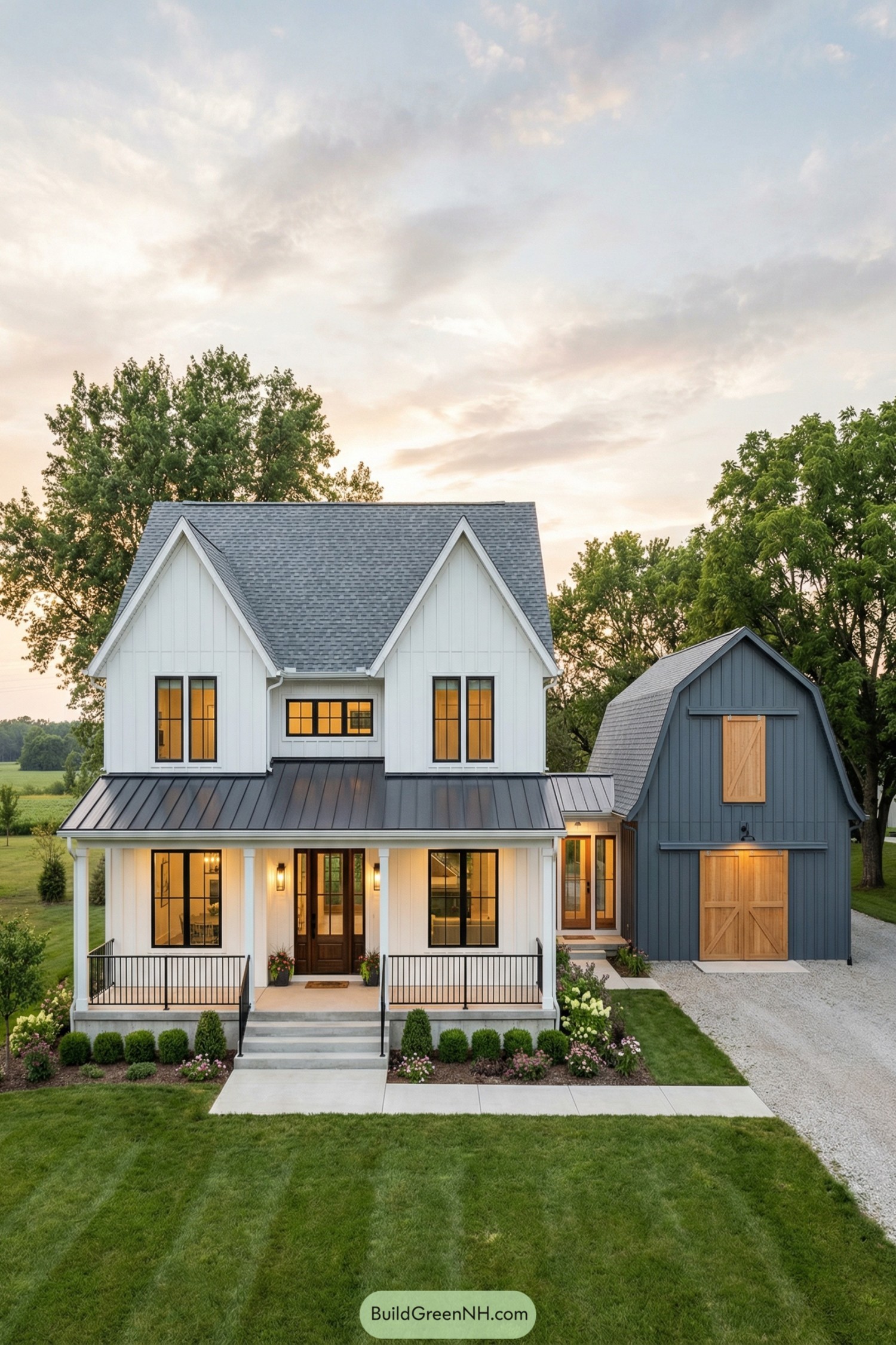 White two story modern farmhouse with attached blue barn style wing and welcoming front porch