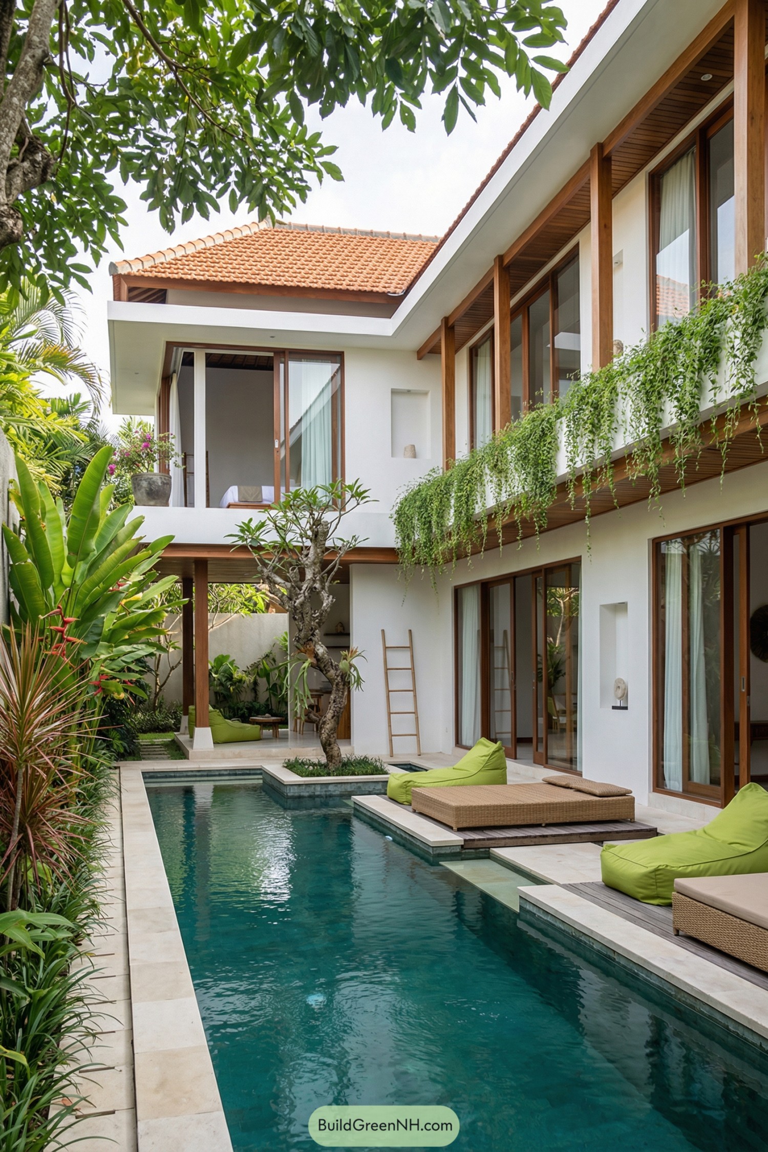 Modern white villa with narrow pool courtyard and hanging greenery