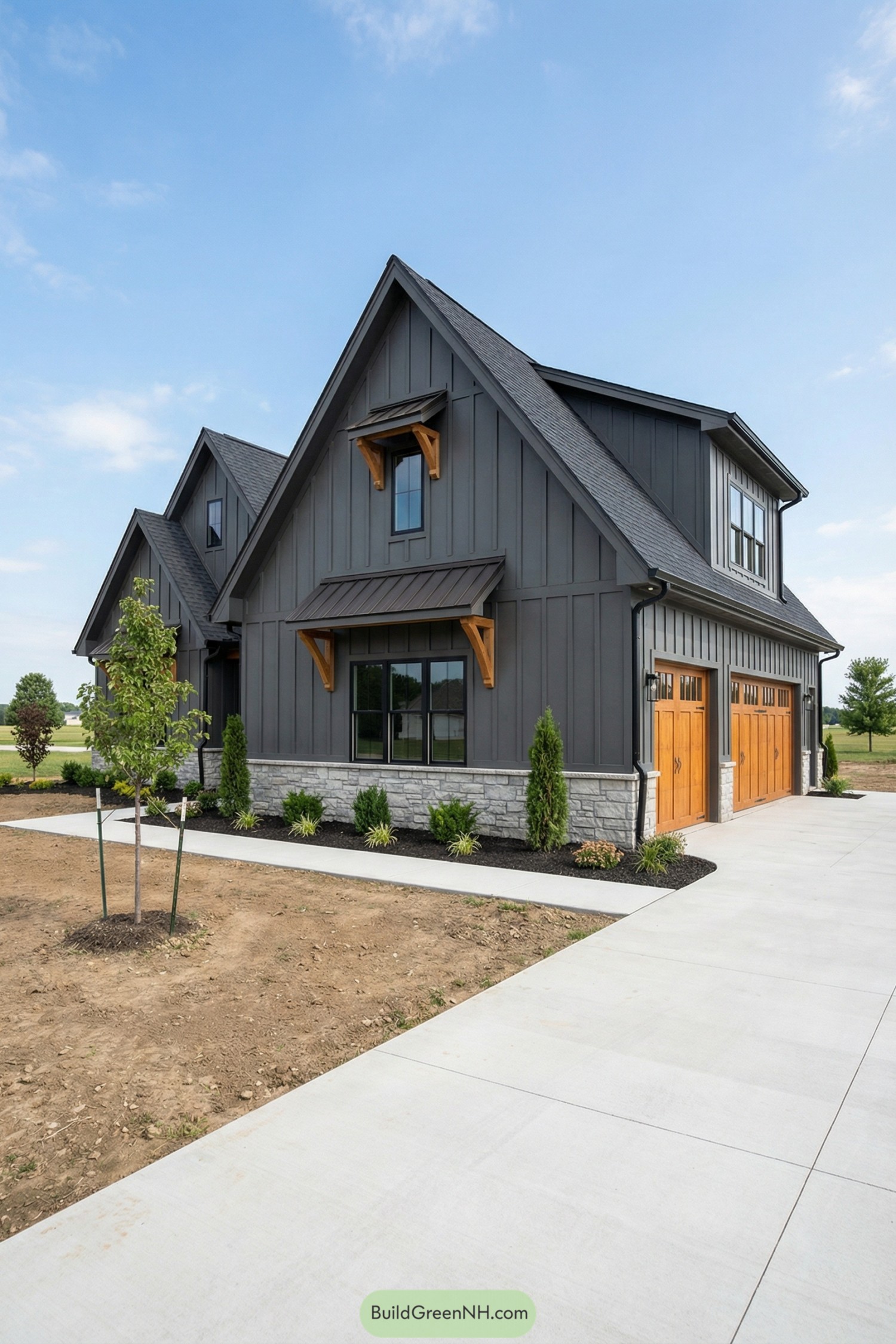 Dark board and batten cottage with stone base and warm wood garage doors