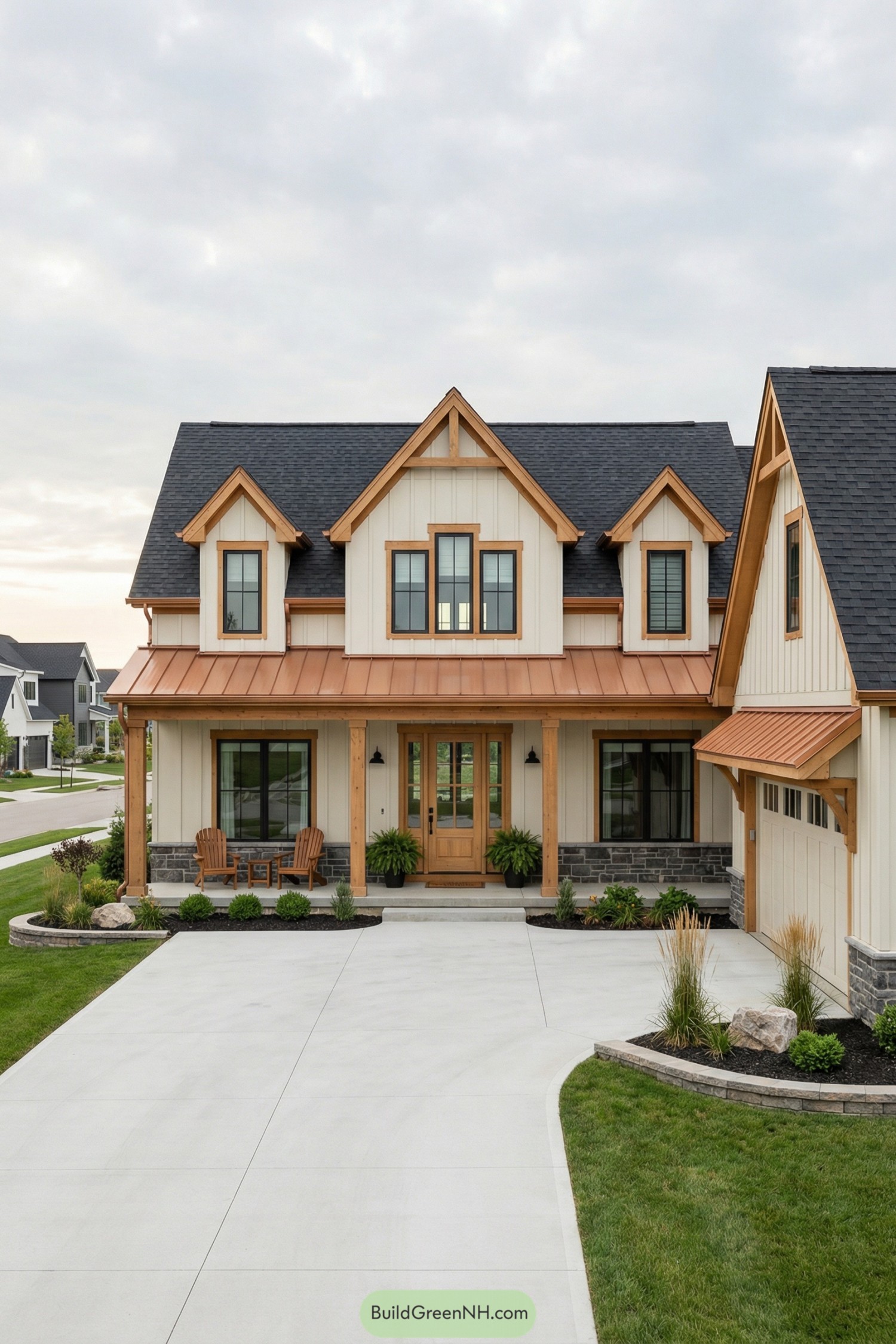 Cream siding cottage with copper roof accents and front porch facing a clean driveway and neat lawn
