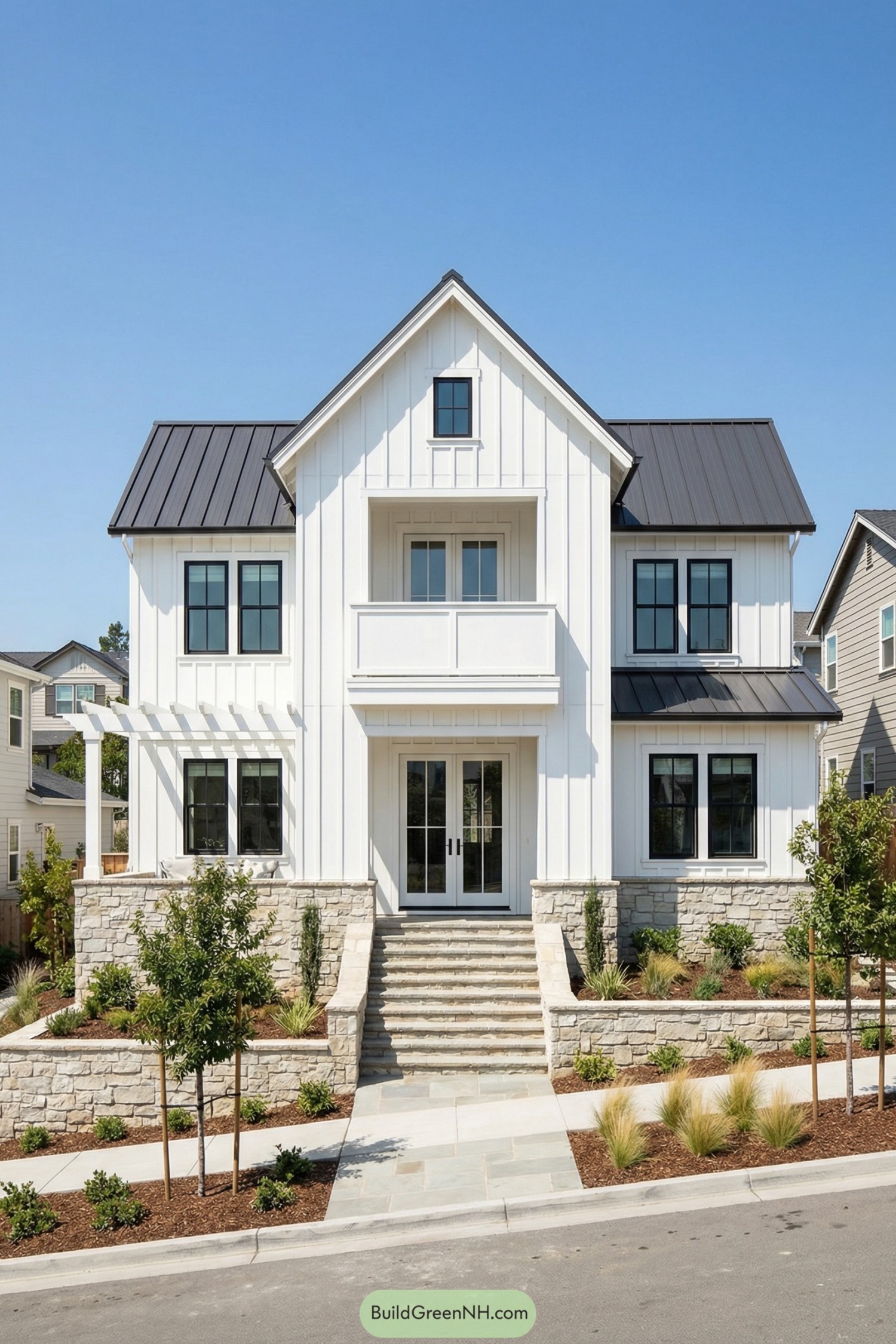 White modern farmhouse cottage with black roof and stone terraces