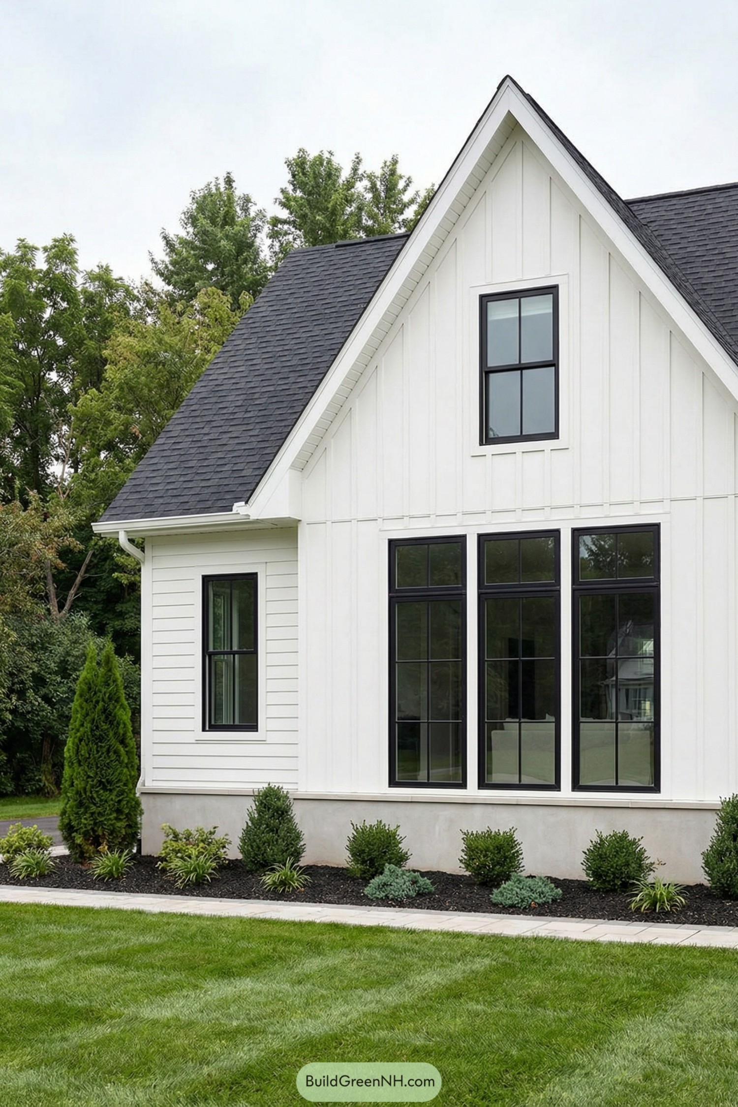White farmhouse exterior with tall black framed front windows