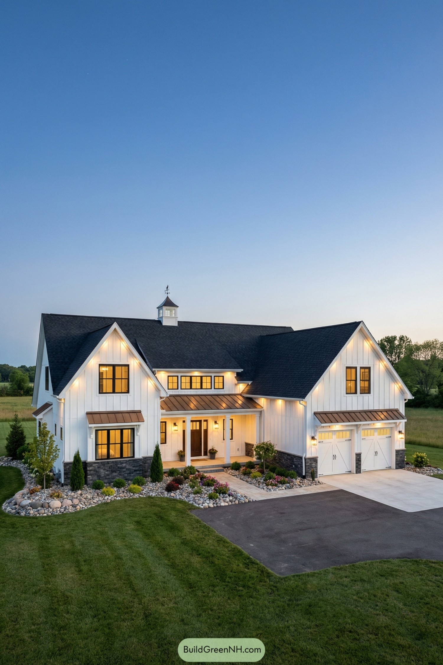 Modern white farmhouse with copper roof accents and warm exterior lighting at dusk
