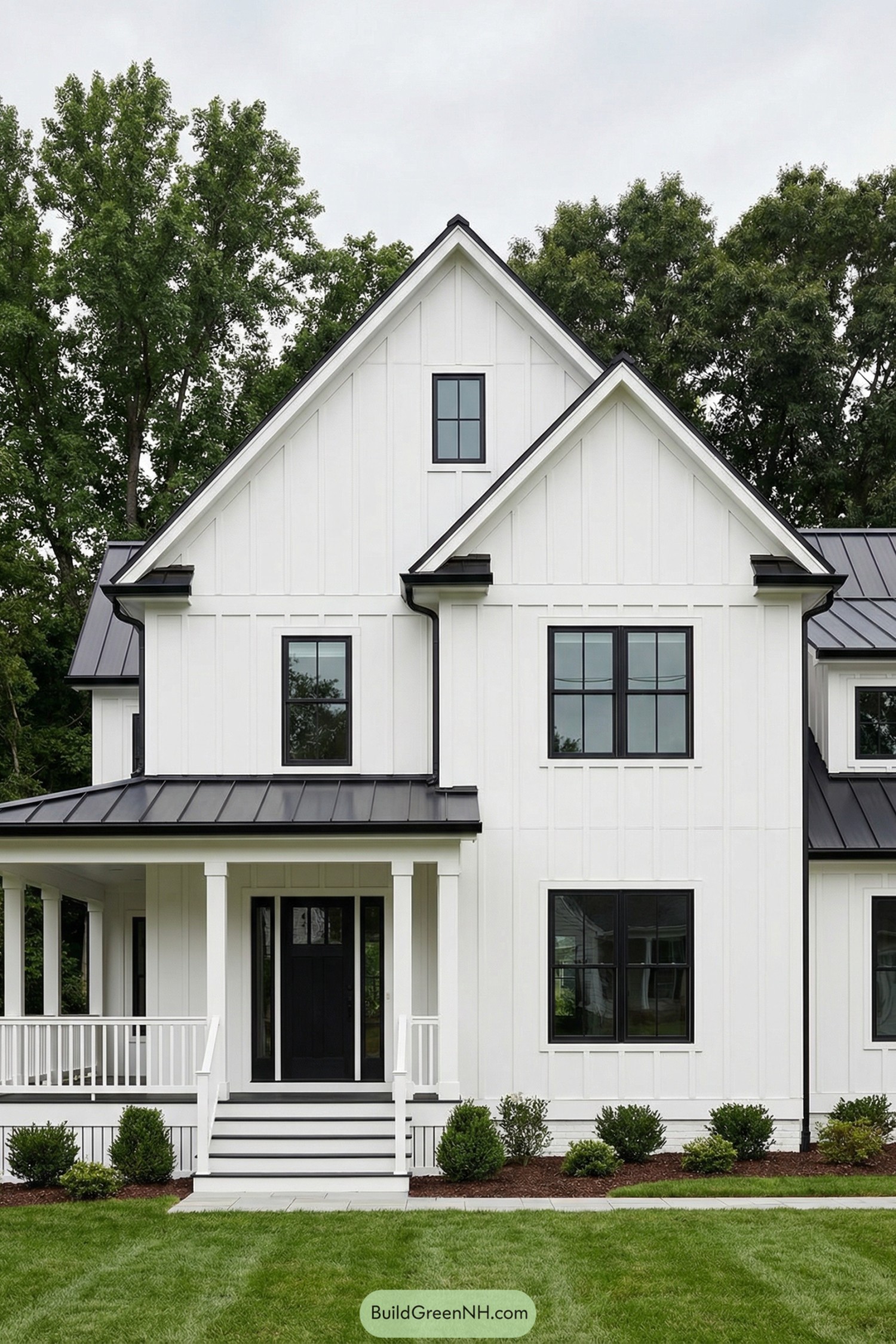 White farmhouse style home with black metal roof and black framed windows