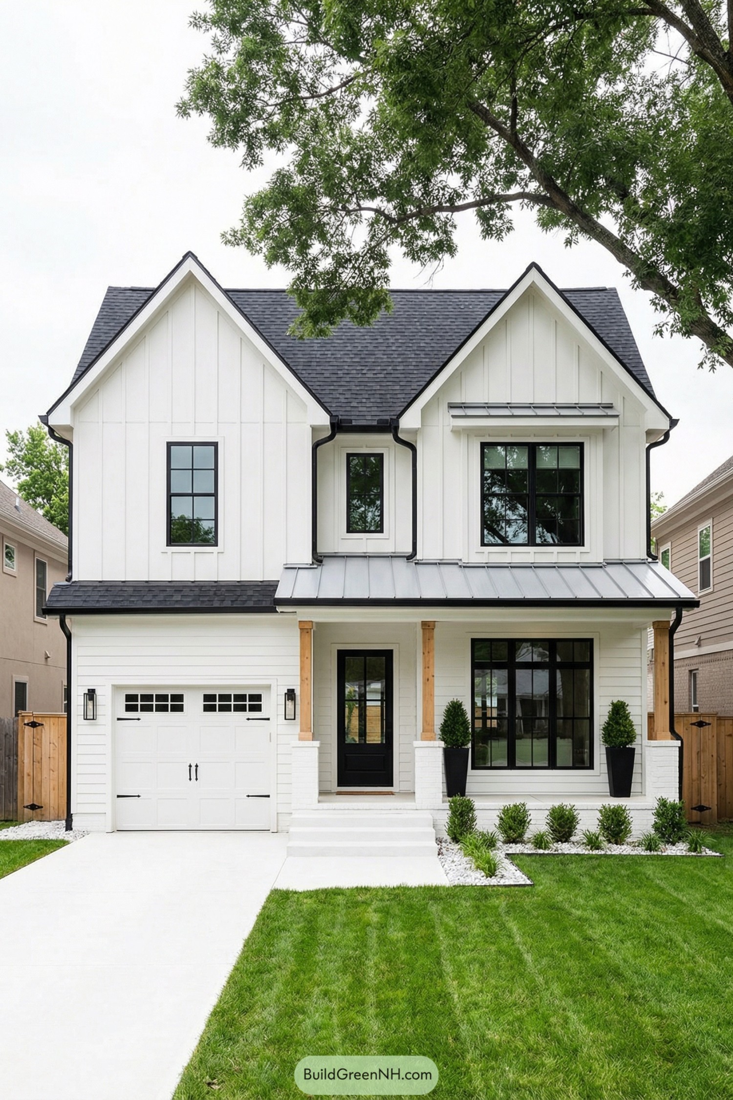White modern farmhouse exterior with black windows, metal porch roof, and simple front lawn landscaping
