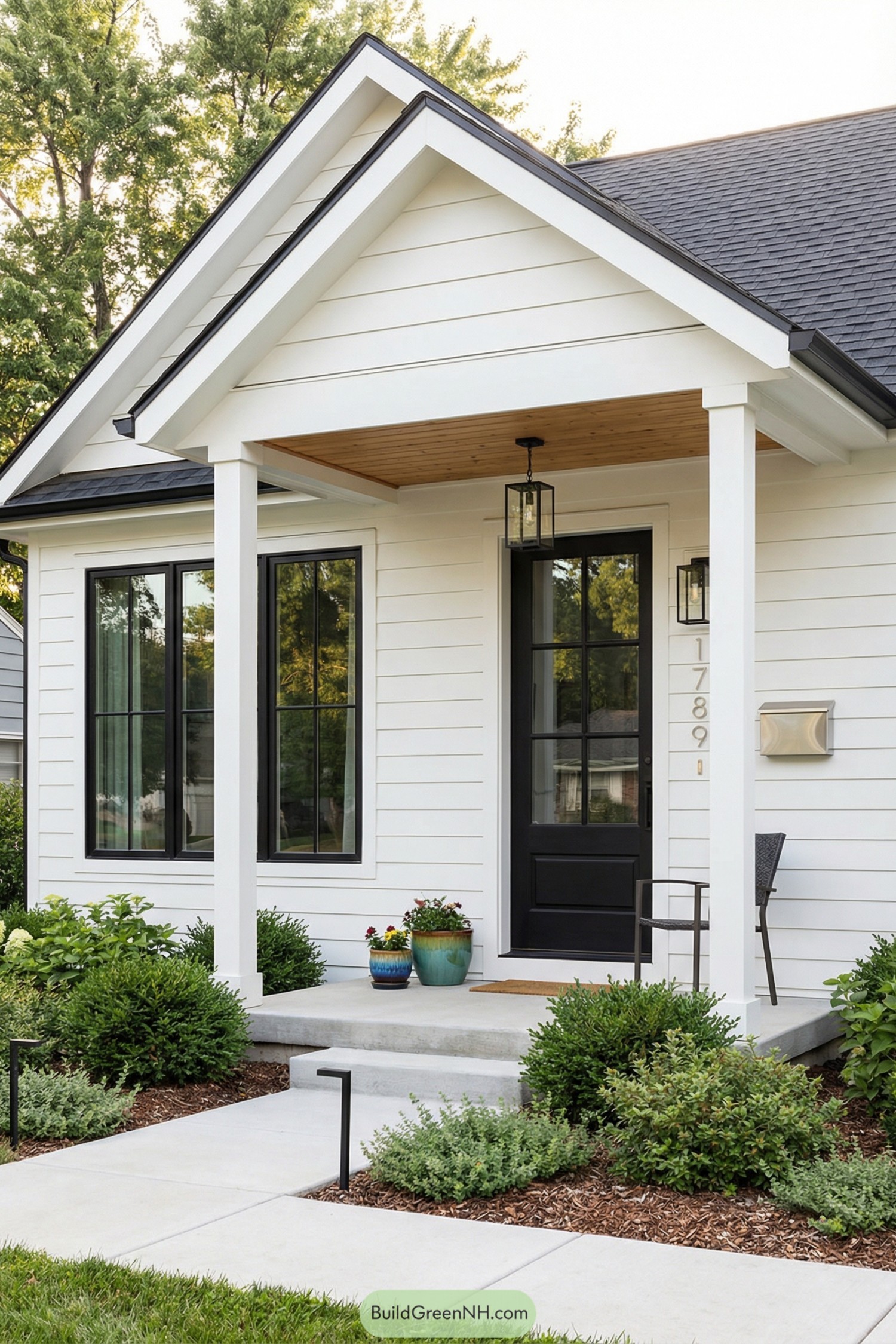 White farmhouse porch with black door and windows
