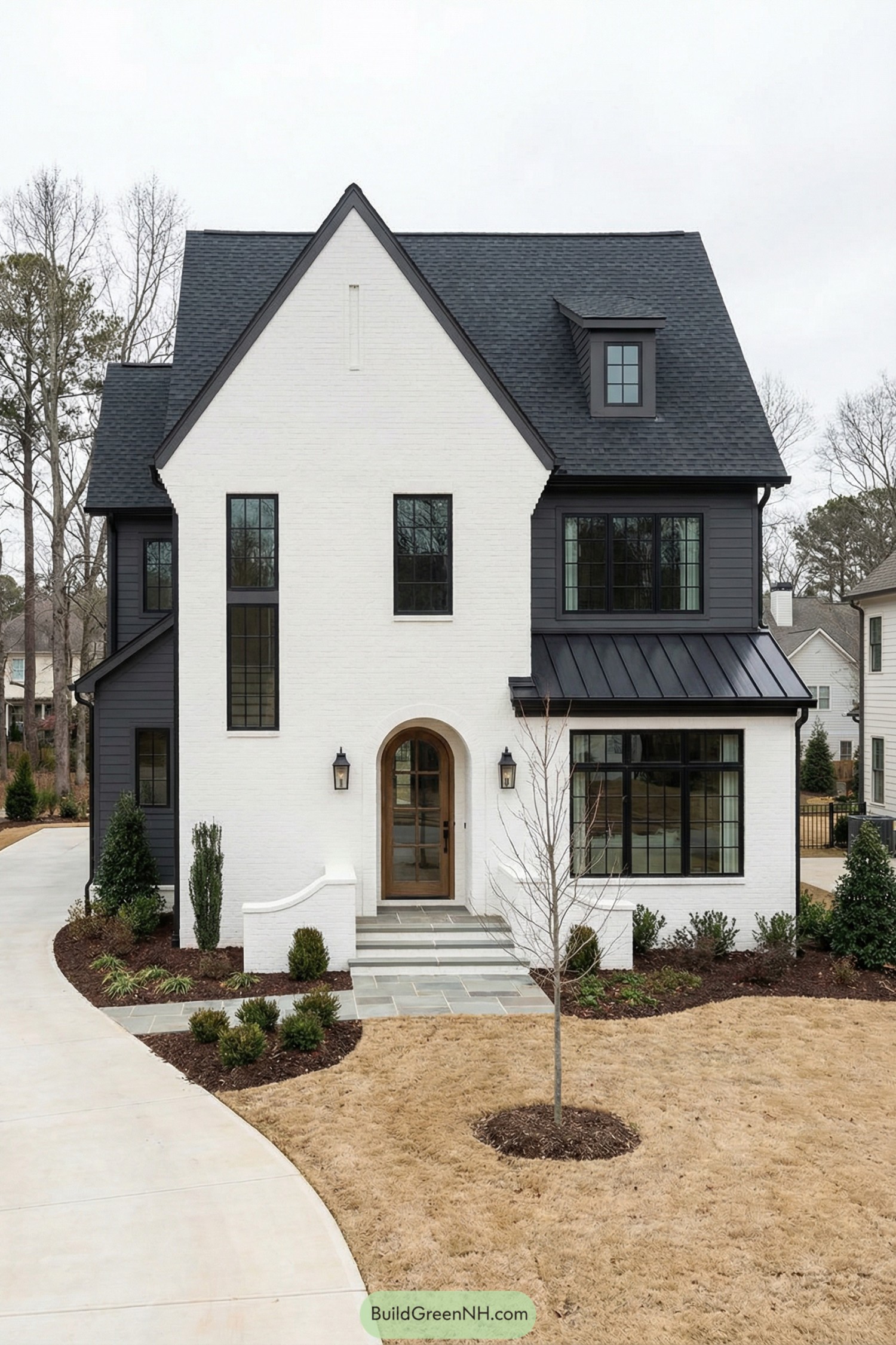White brick house with black roof and trim