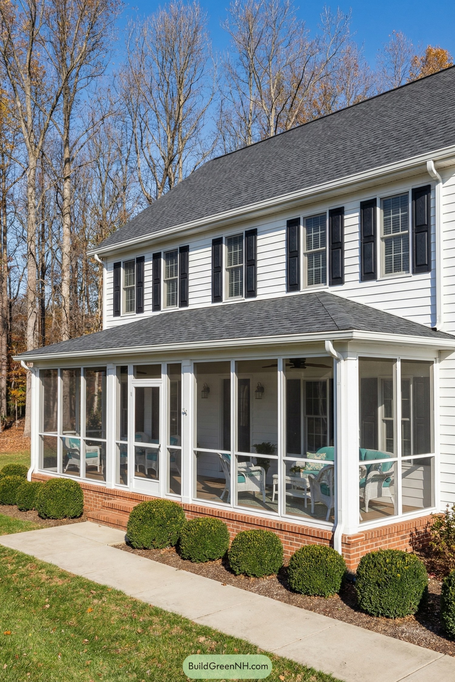 White colonial home with screened front porch