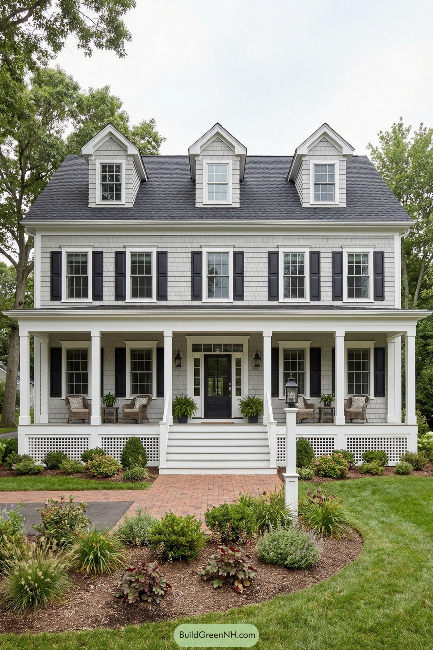 Two story gray shingle colonial home with full front porch and dormer windows