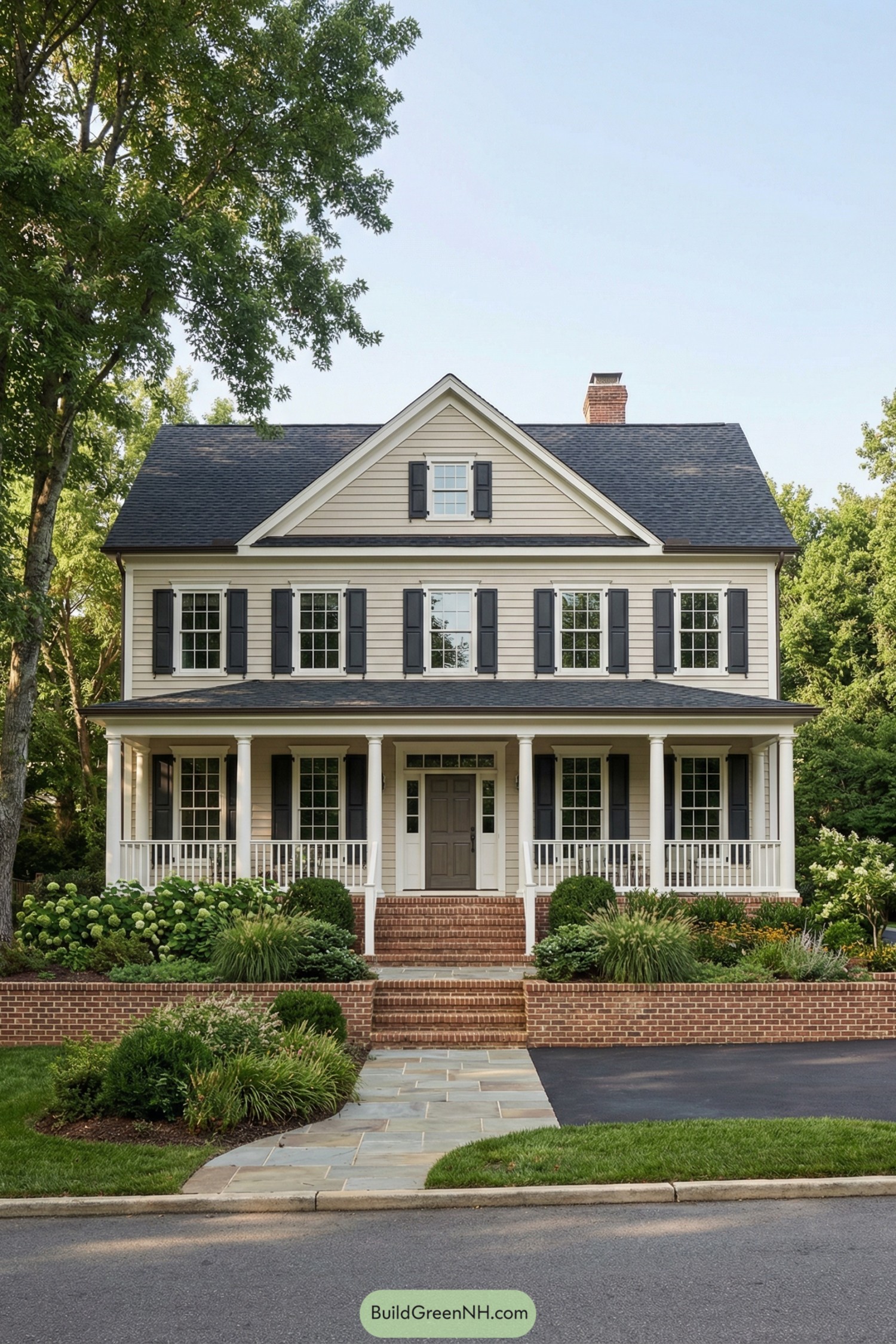 Two story beige colonial home with full front porch