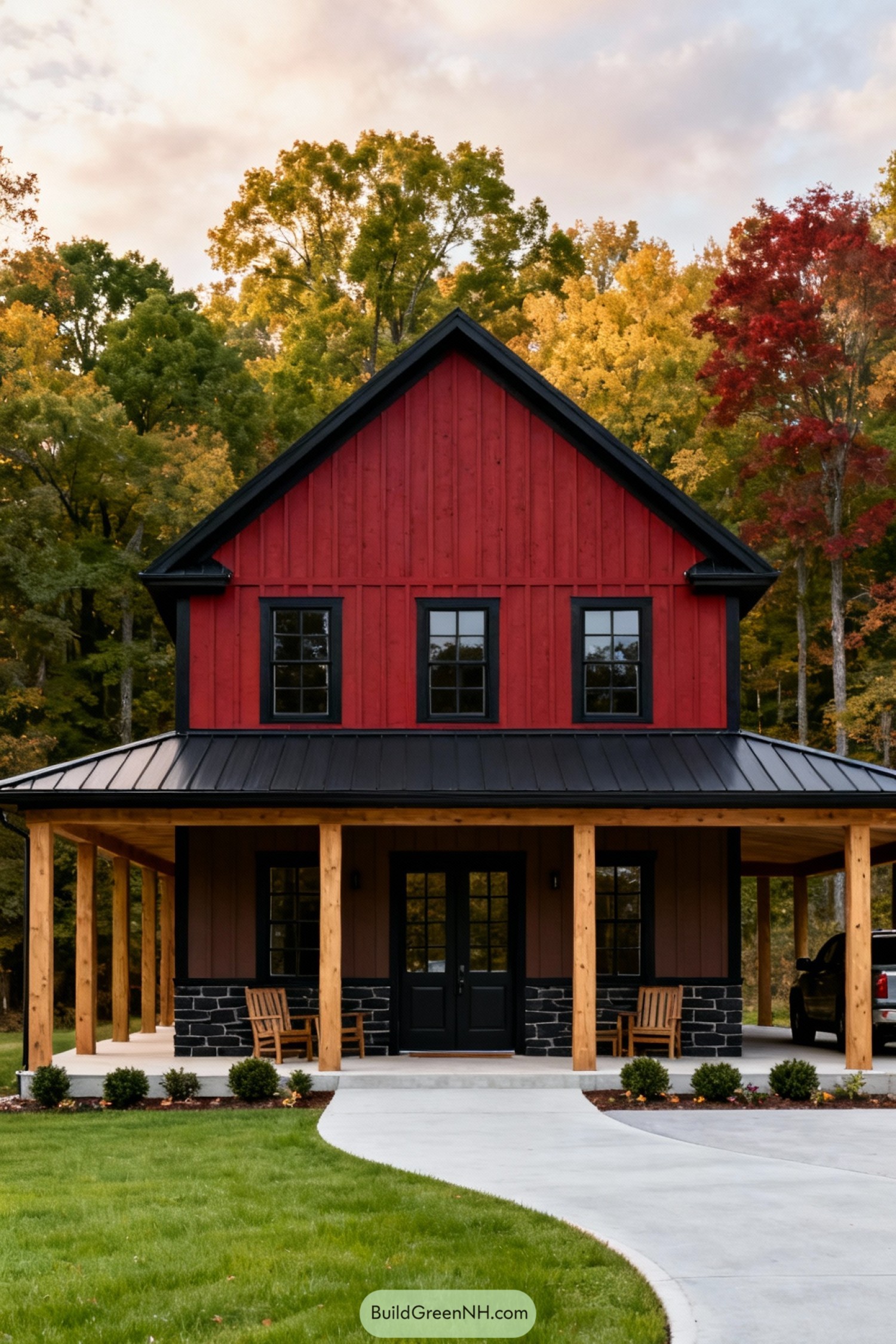 Red barn style home with black roof and wraparound porch in a wooded setting