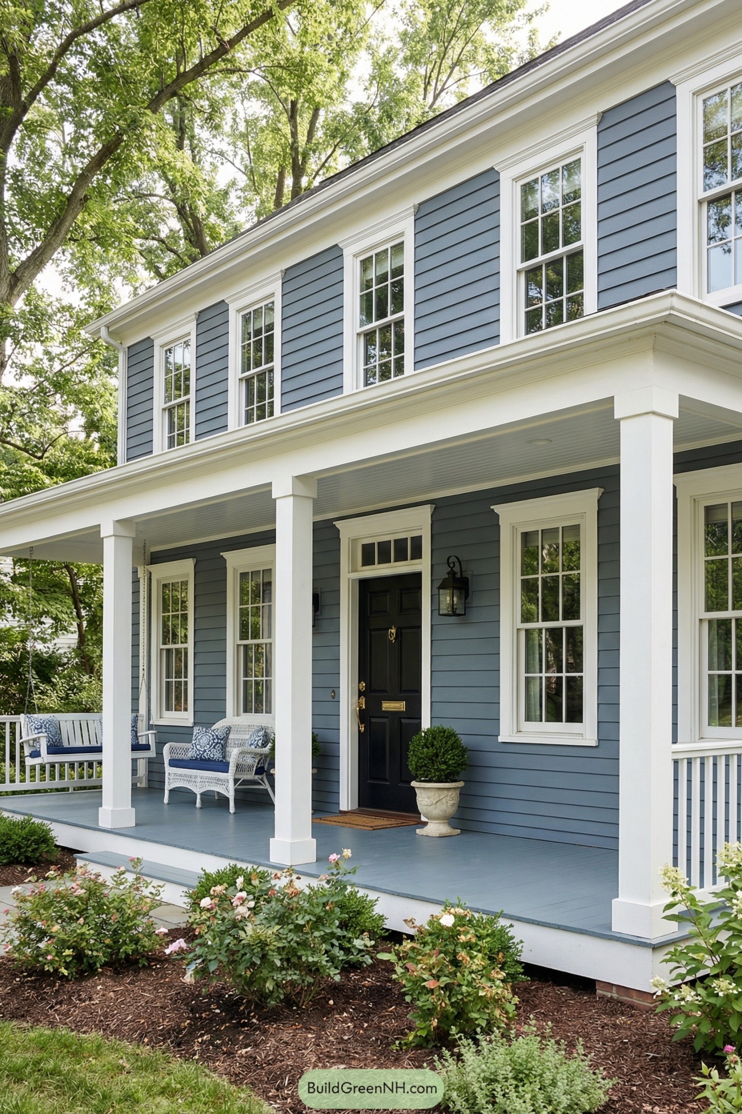 Blue colonial house with white trim and wide front porch