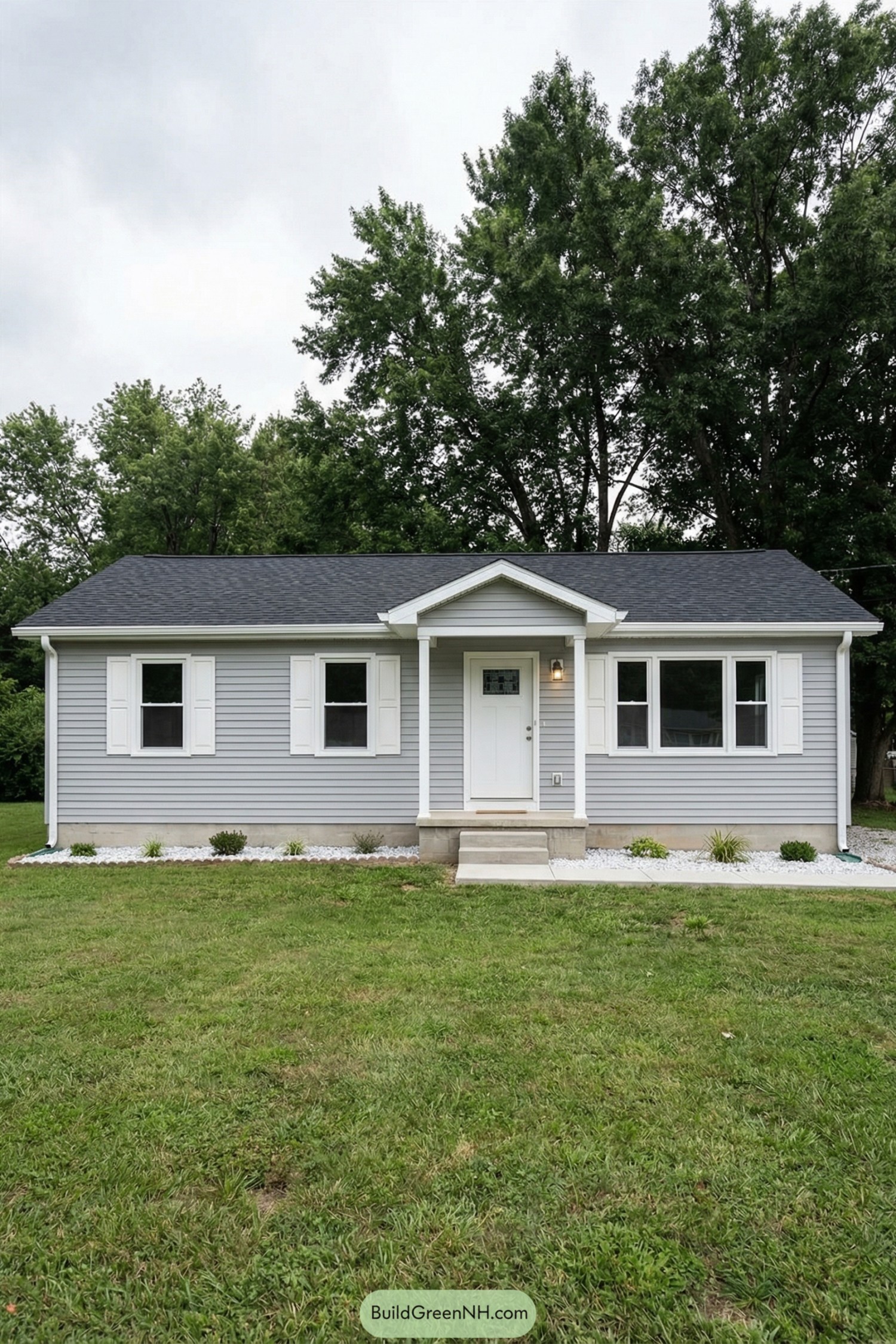 Small gray bungalow with white trim and neat front lawn