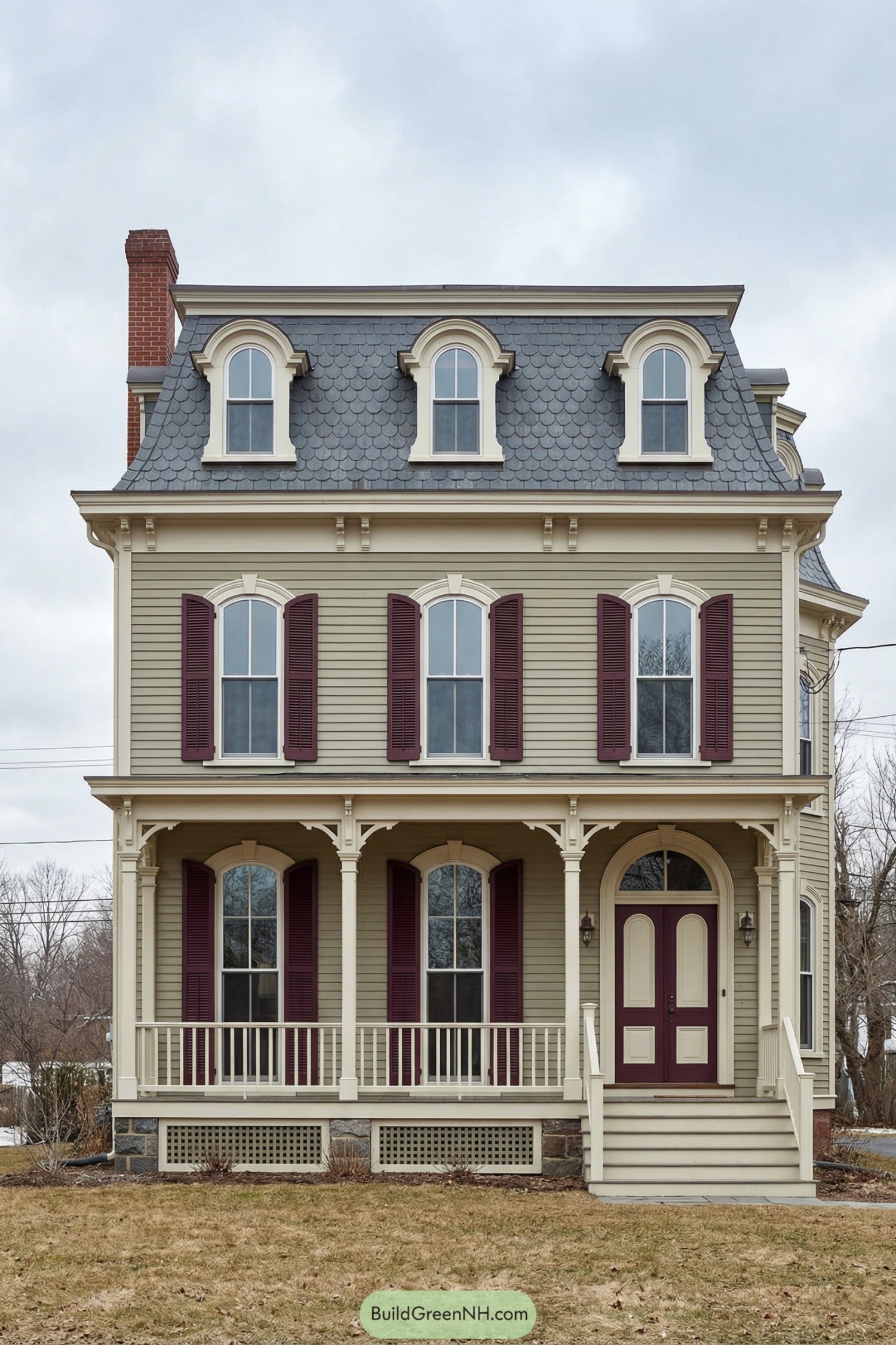 Three story beige house with gray mansard roof and burgundy shutters