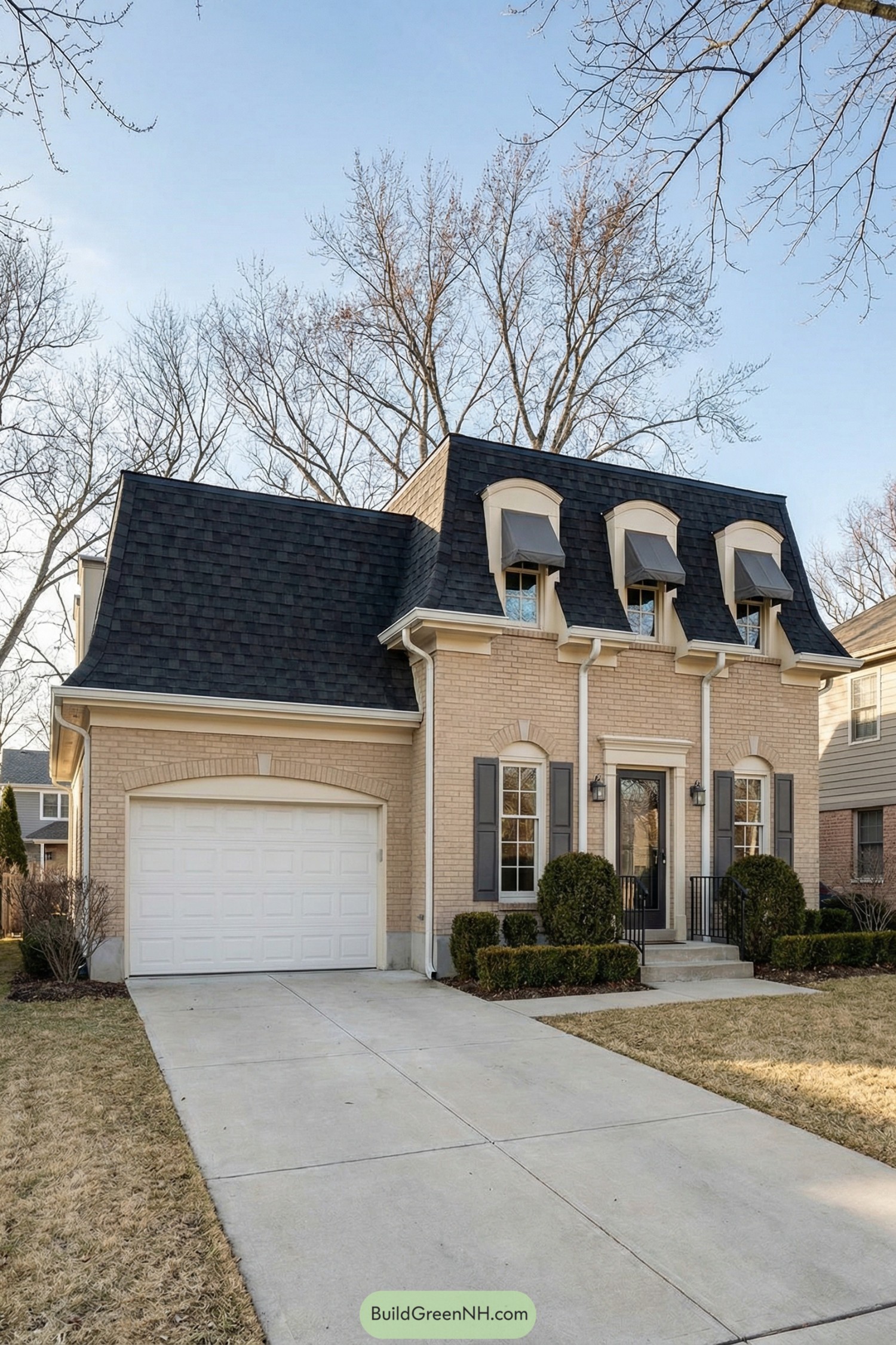 Brick house with black mansard roof