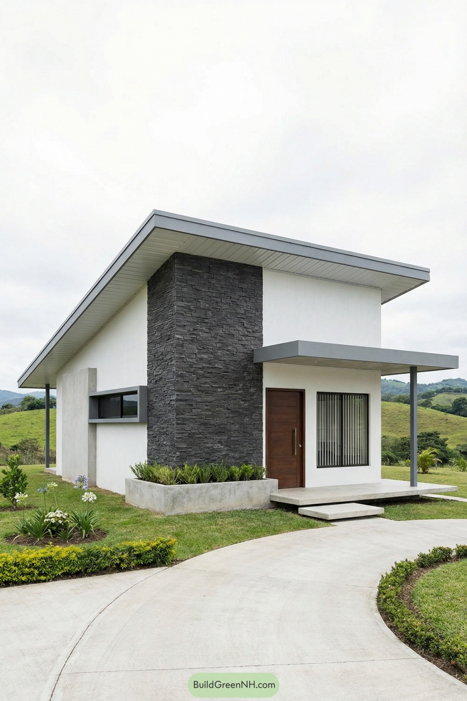 Minimalist small house with sloped roof and stone accent wall set in green hills