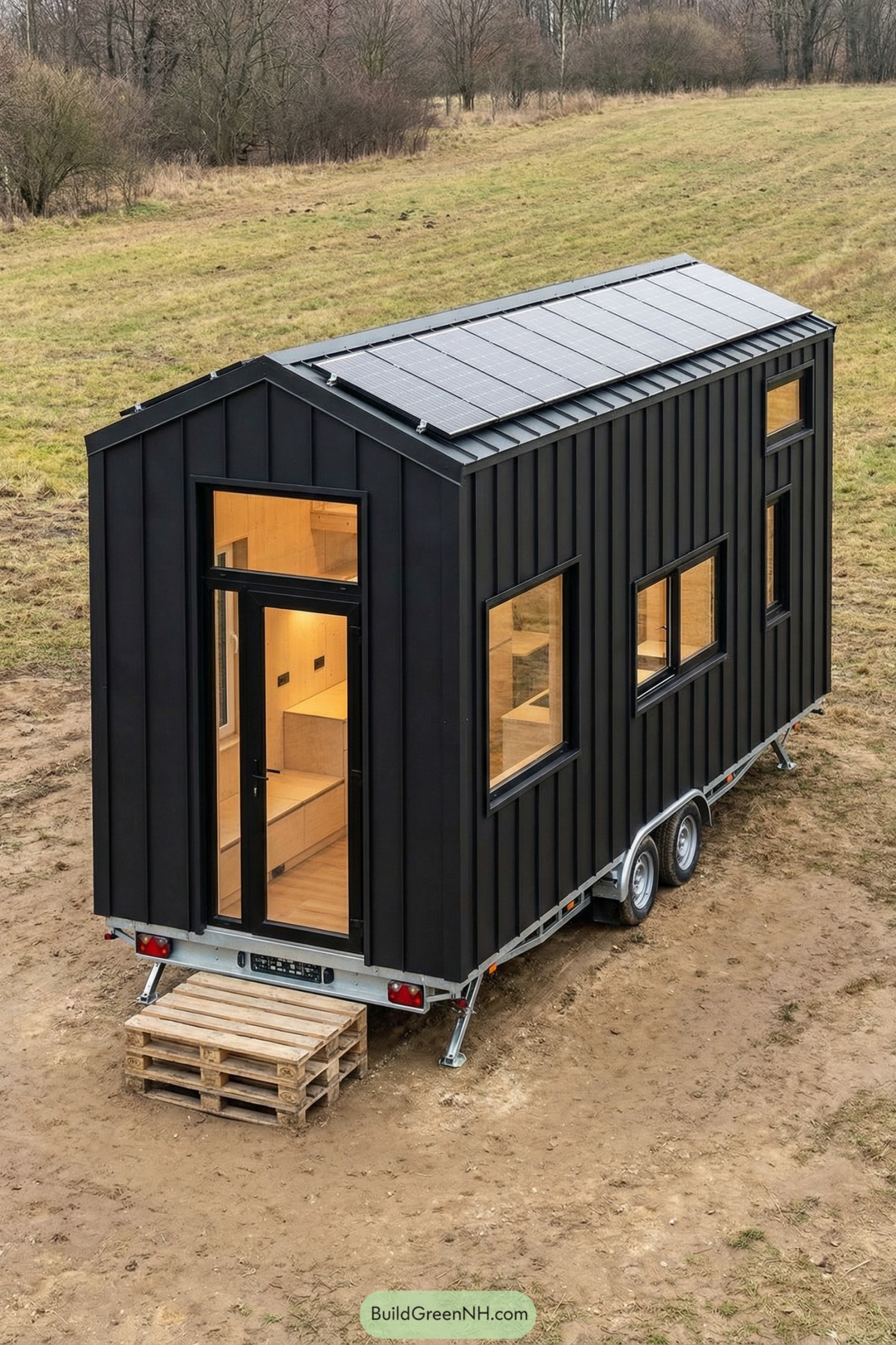 Black metal tiny house on wheels with solar roof panels and warm wood interior