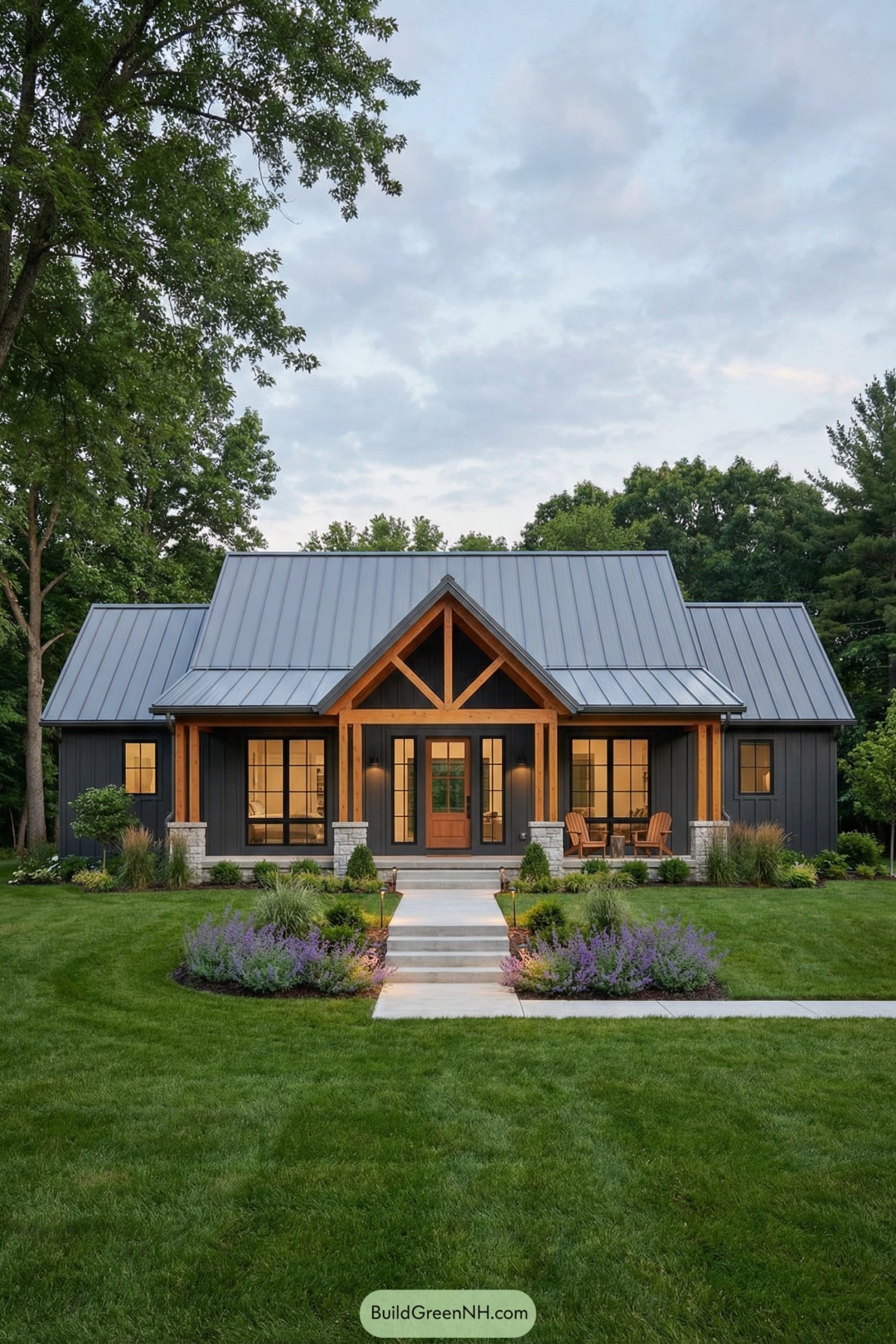 Modern dark cottage with metal roof, timber porch frame, and lush front garden with lavender borders