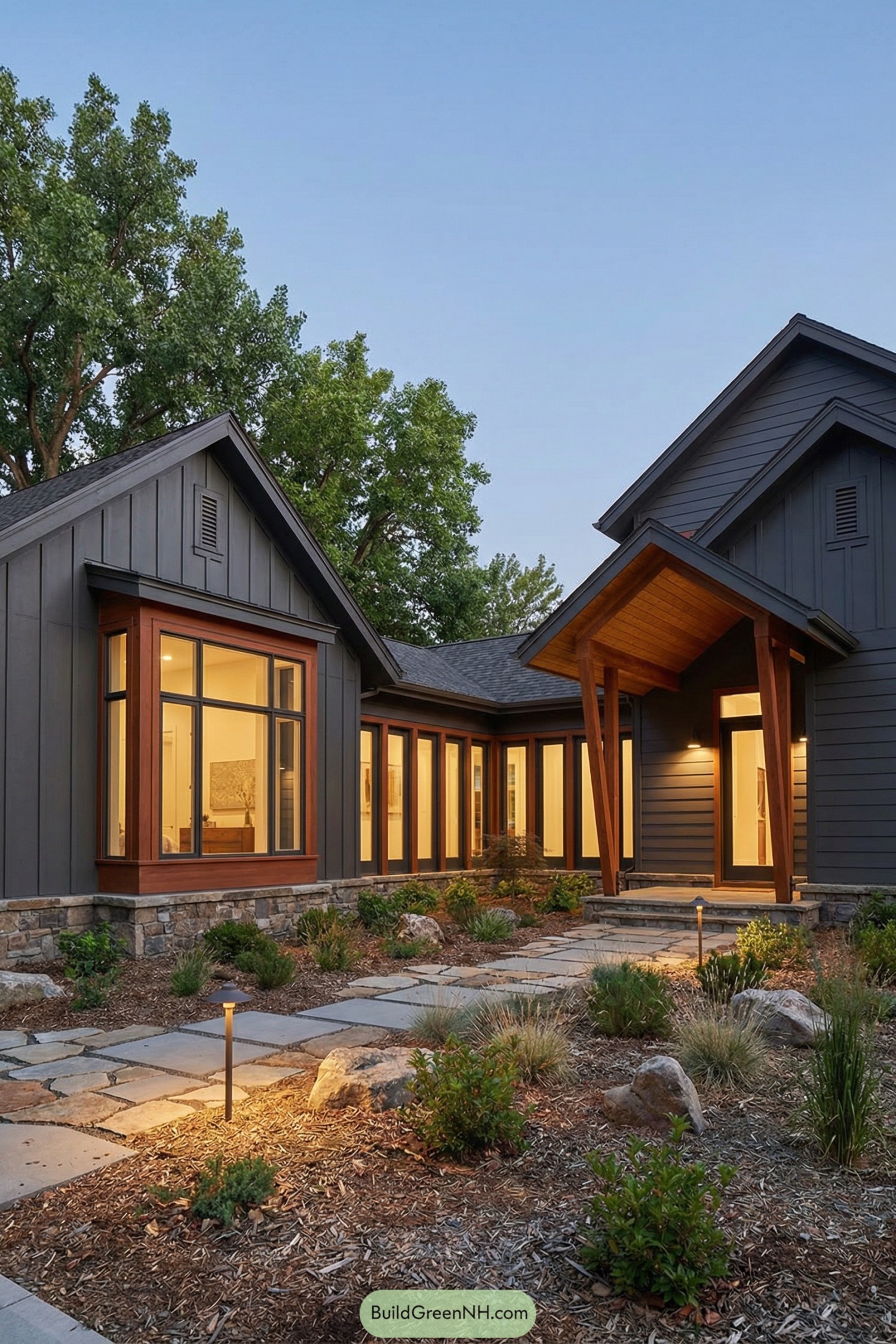 Modern craftsman cottage with dark siding large windows and a welcoming gabled entry