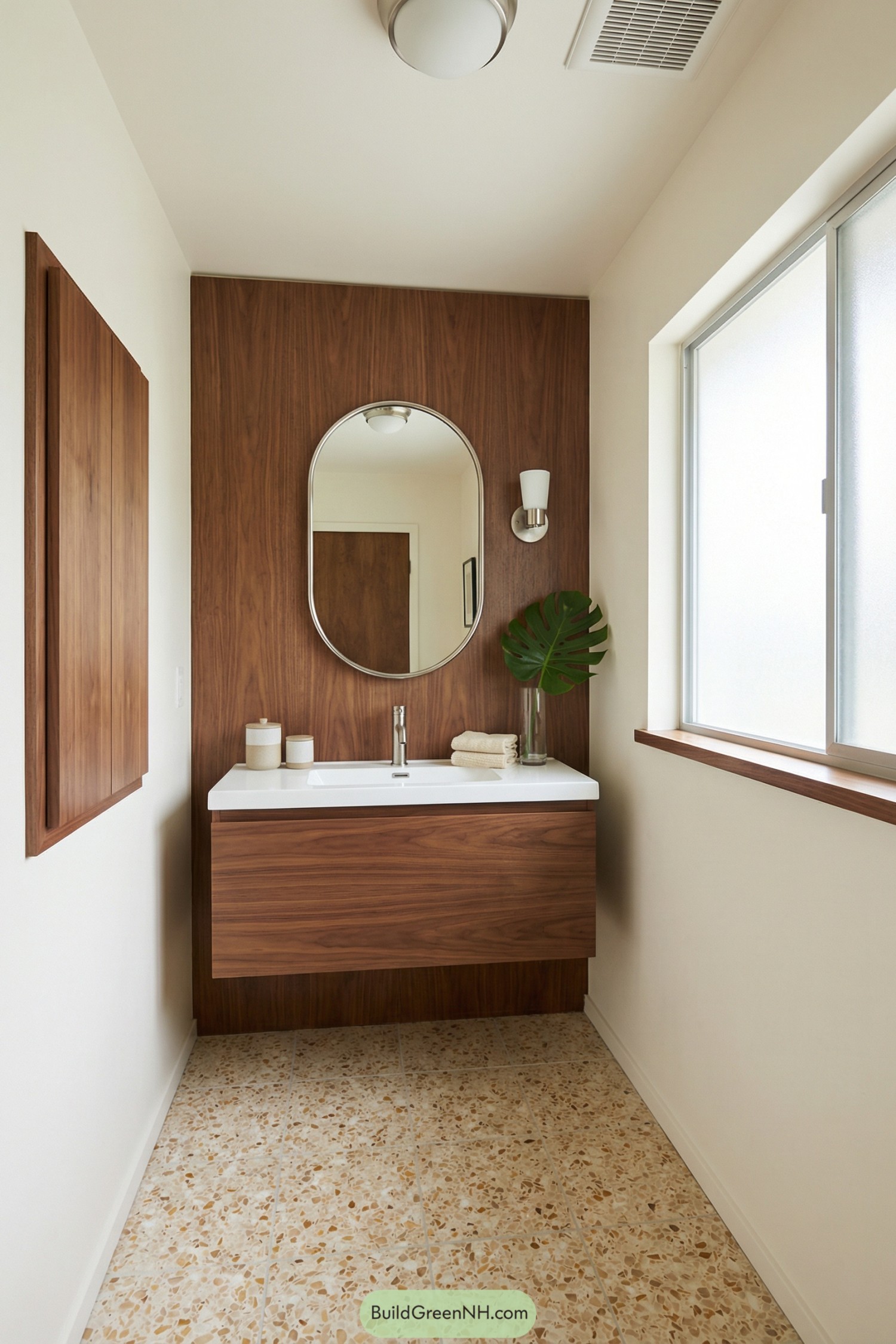 Small bathroom with floating walnut vanity and oval mirror on wood accent wall