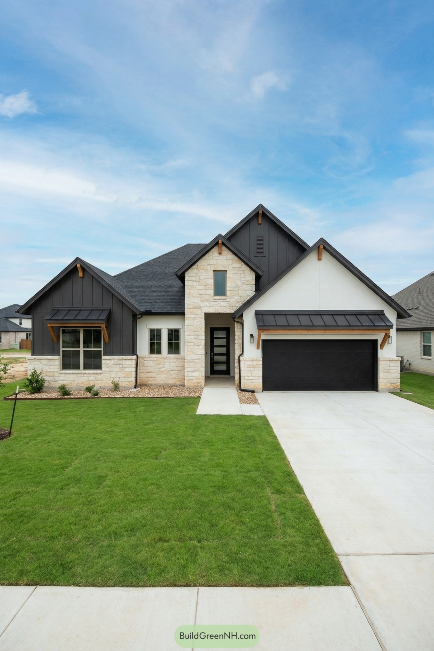 Modern gray and cream stone front house with gabled roof and black garage