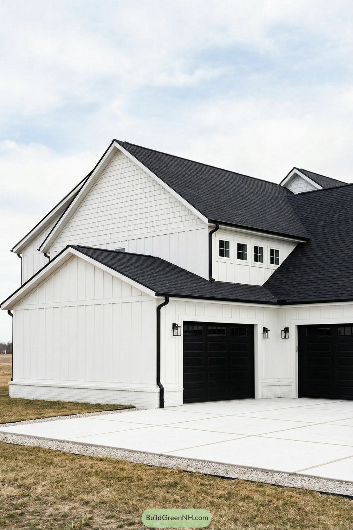 White farmhouse with black roof and double black garage doors