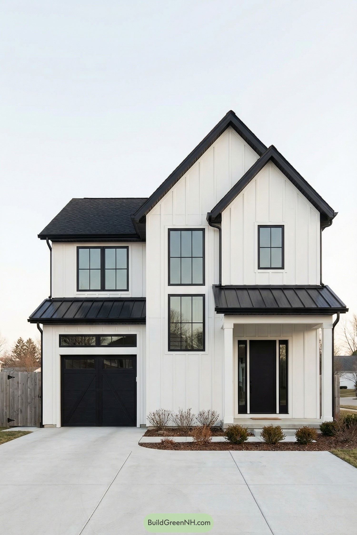 Modern white two story home with black roof and trim