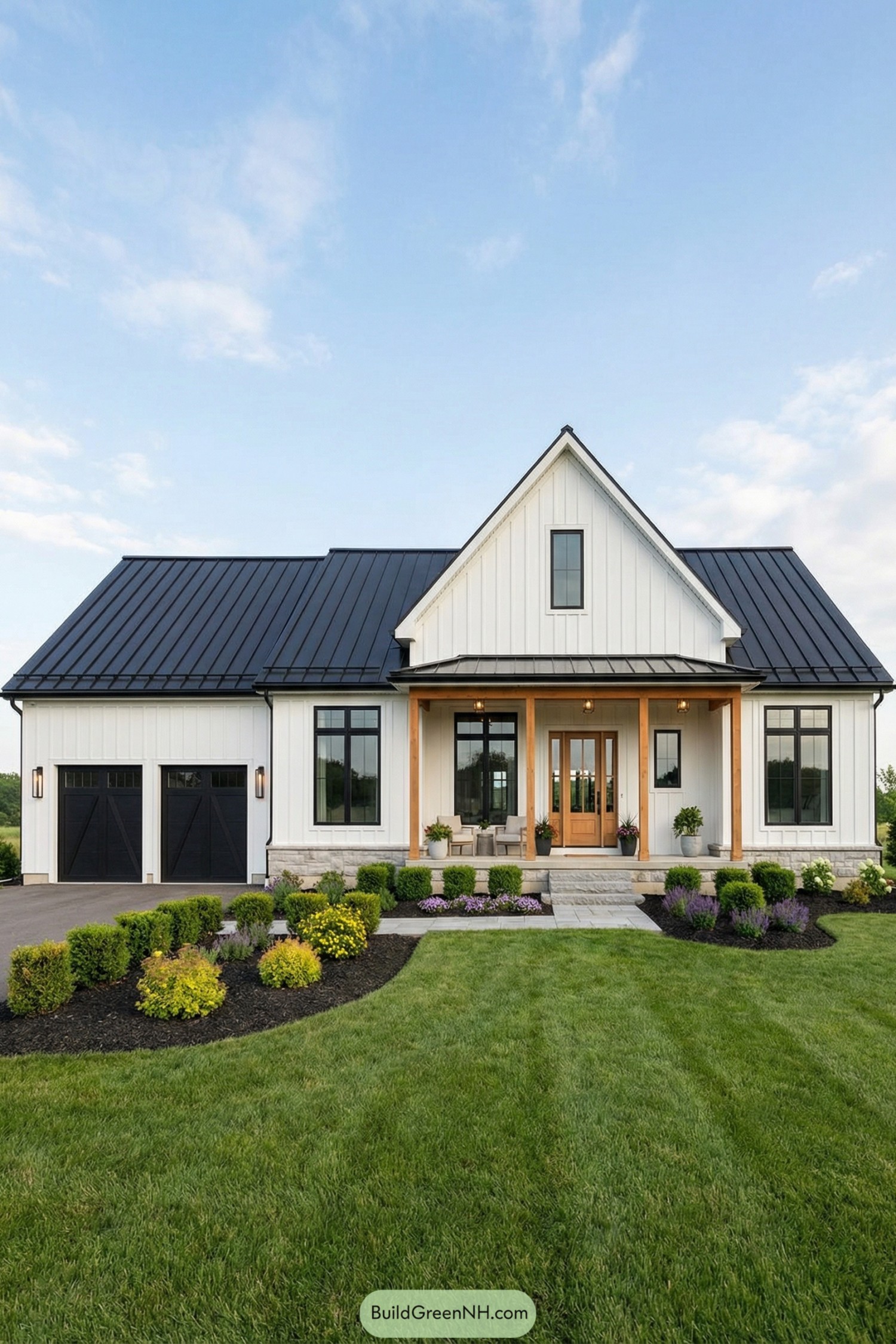 White farmhouse with black metal roof and warm wood front porch