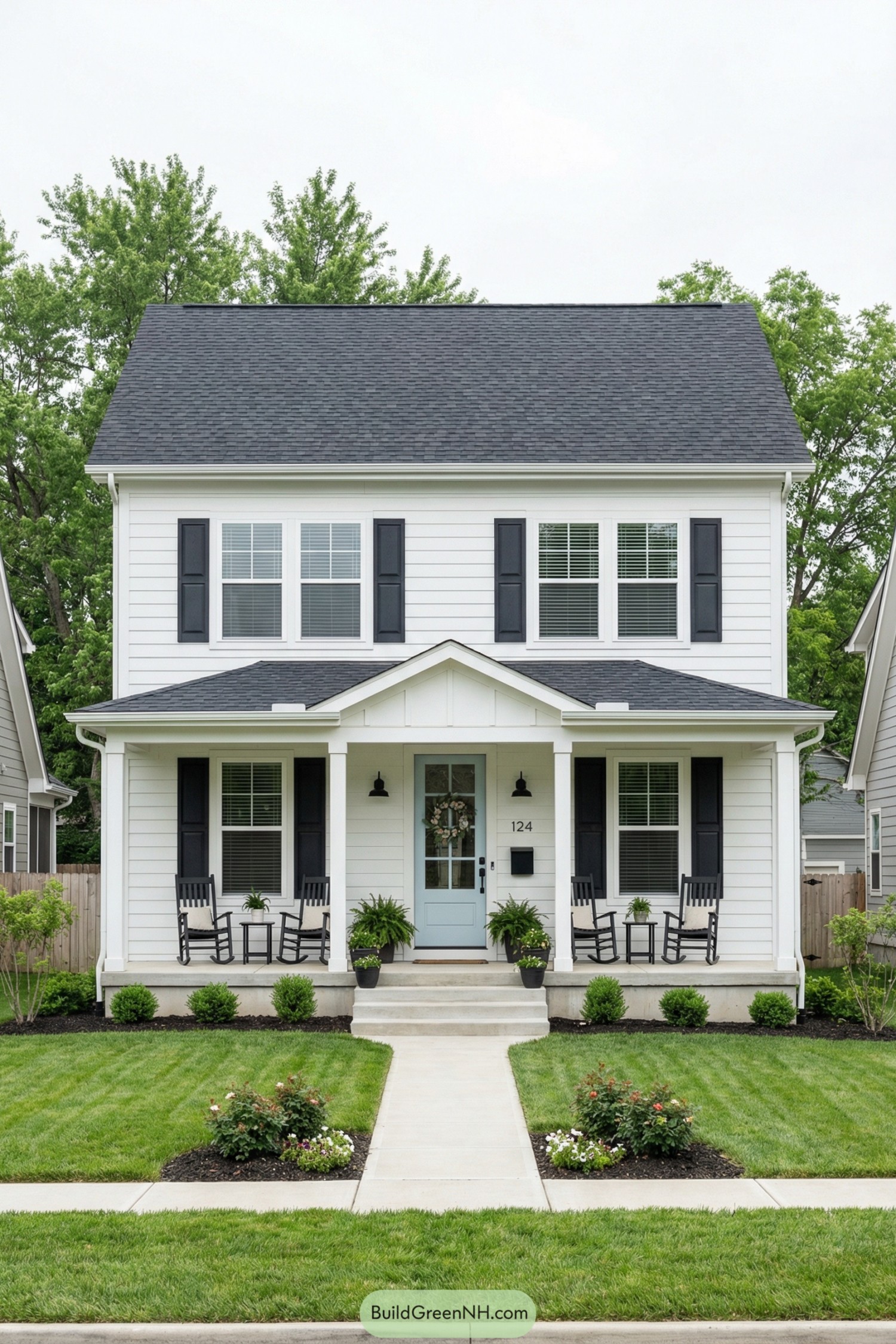 White two story house with black shutters aqua front door and tidy front porch
