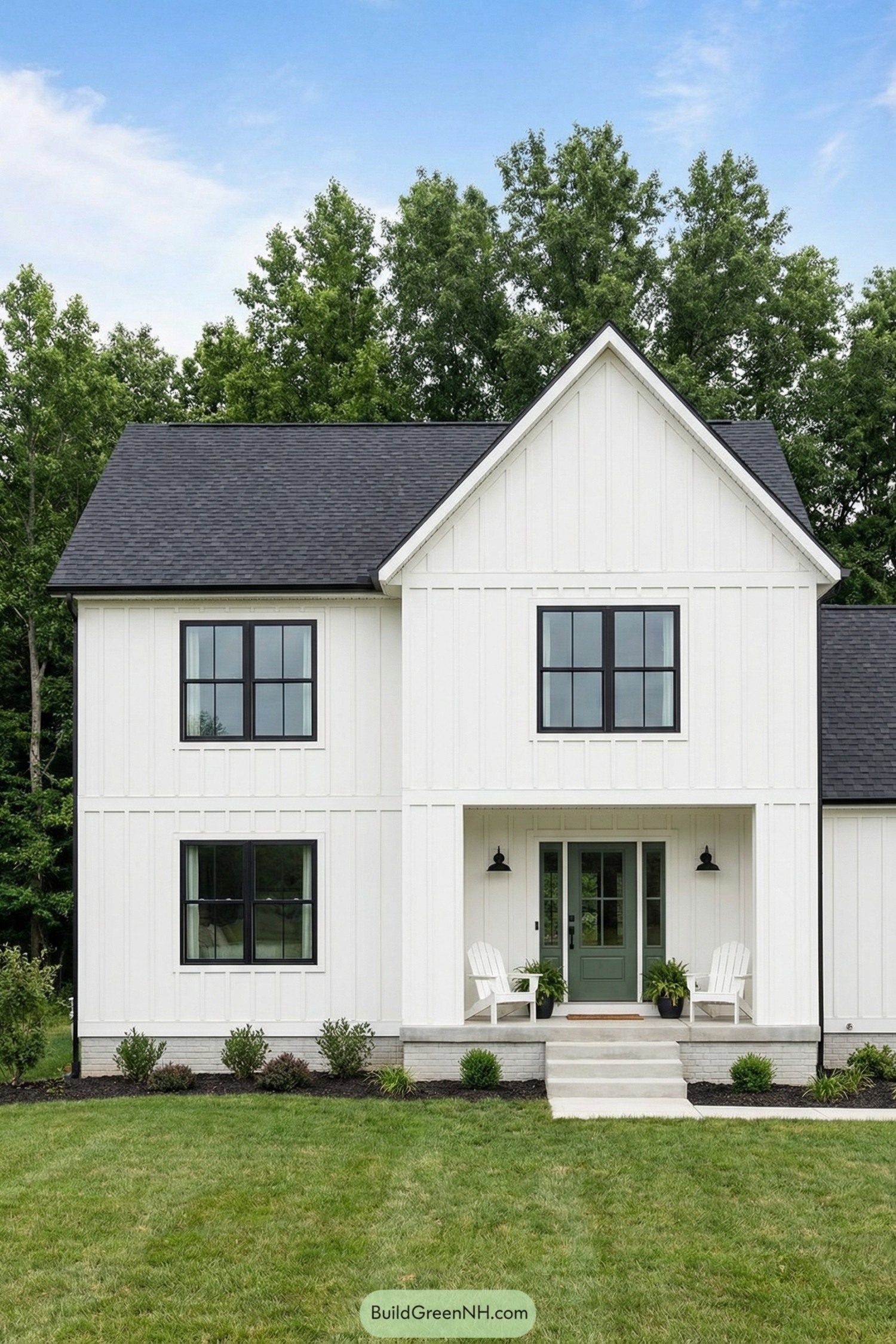 White farmhouse with black windows and green front door
