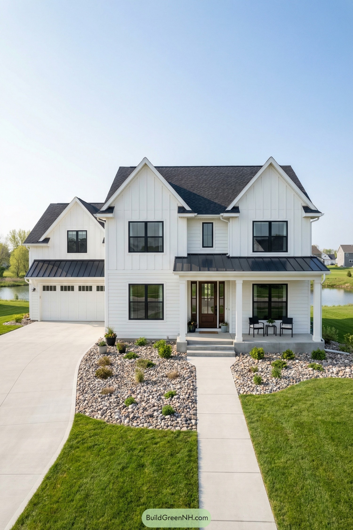 White modern farmhouse with black windows and tidy rock landscaping