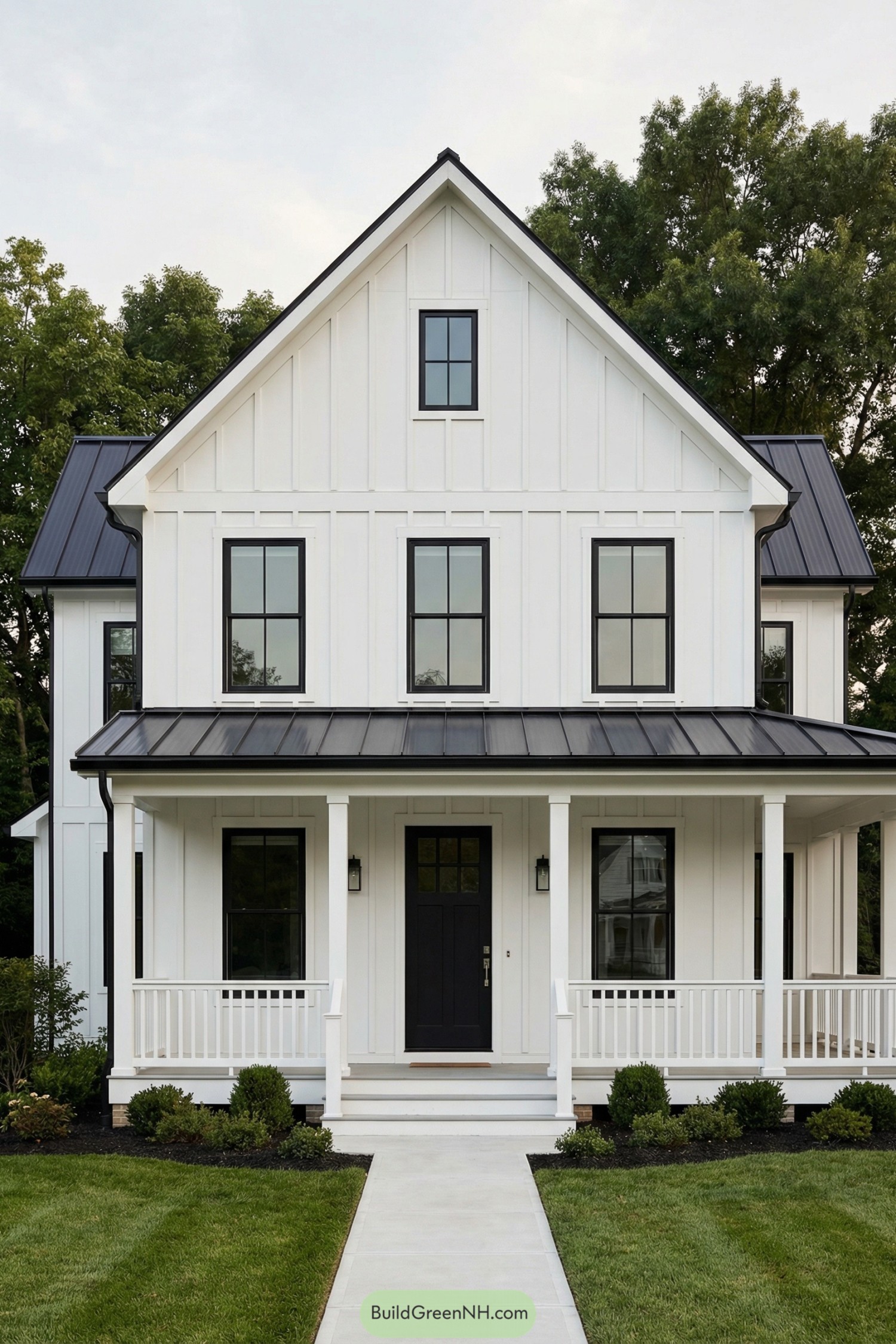 White farmhouse with black windows and covered front porch