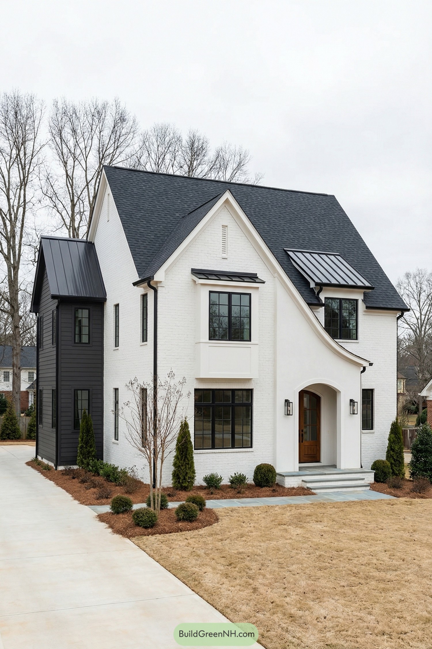 White brick house with steep dark roof and black framed windows