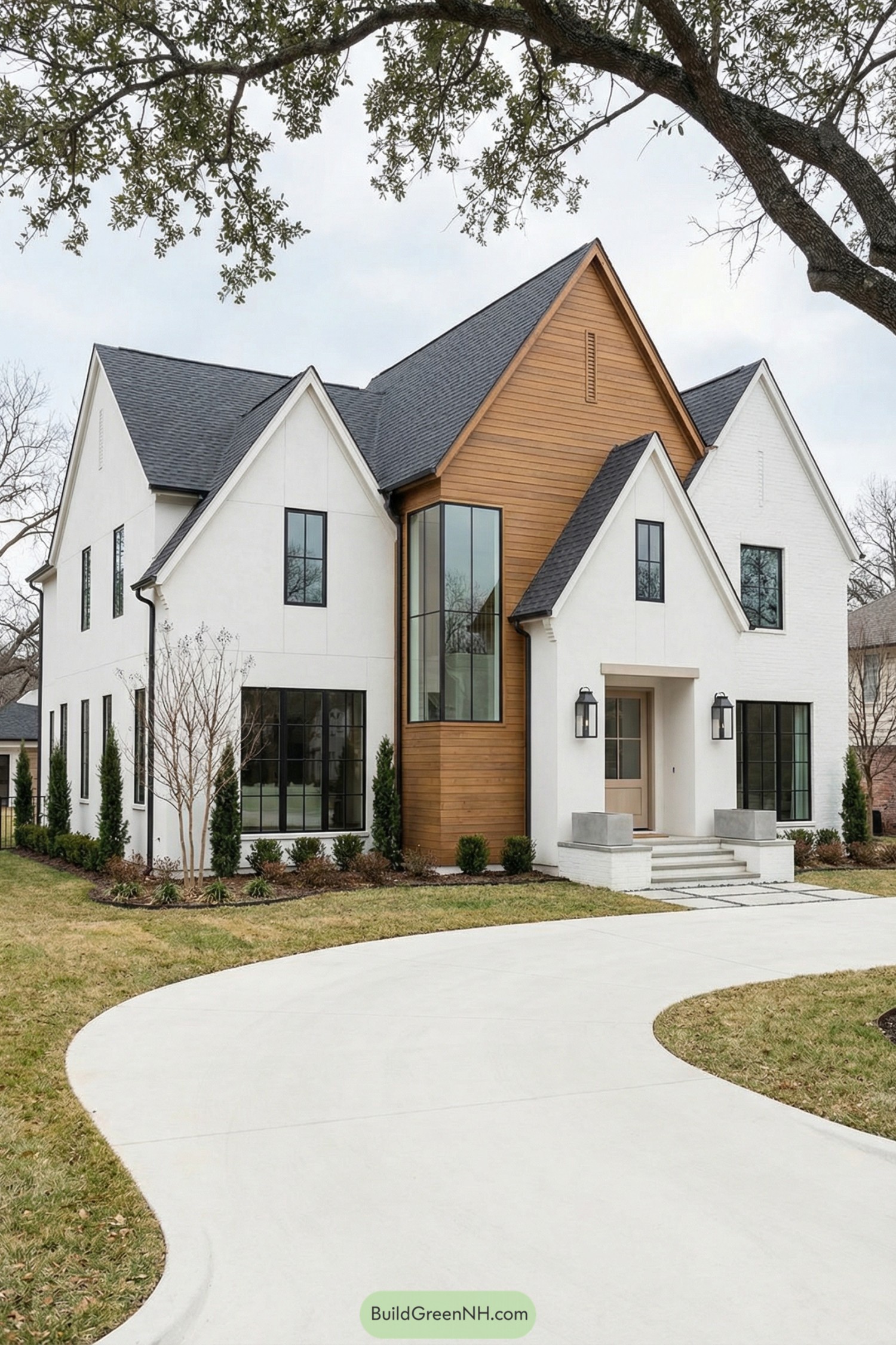 White stucco house with steep gables, tall windows, and a warm cedar accent volume at the entry