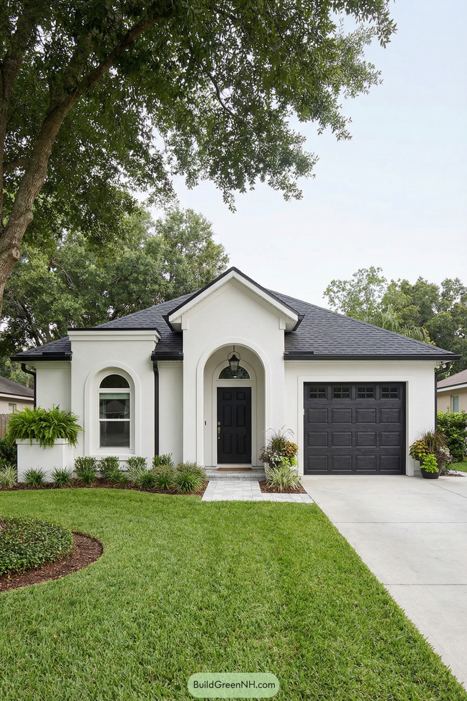 White stucco house with black accents and arched entry