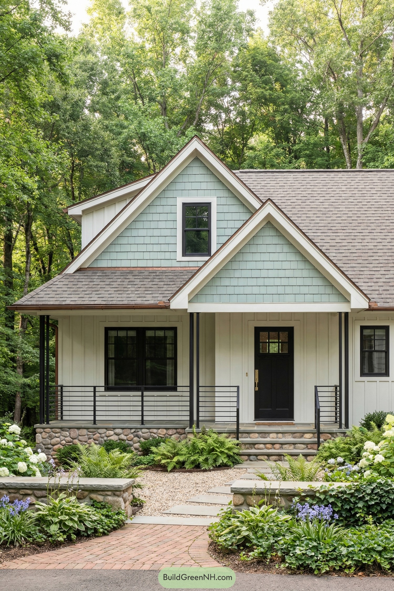 Soft green gabled cottage with stone base and lush garden path