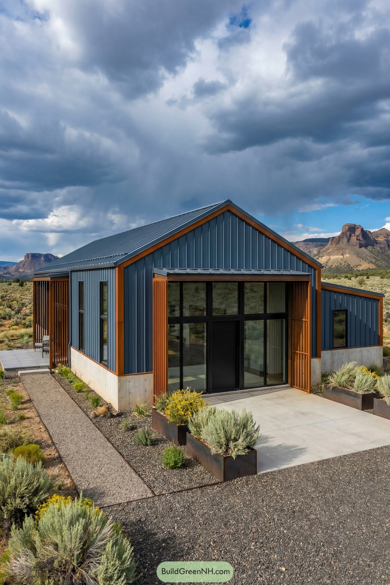 Modern blue metal ranch barndominium entry with wood accents in a desert landscape