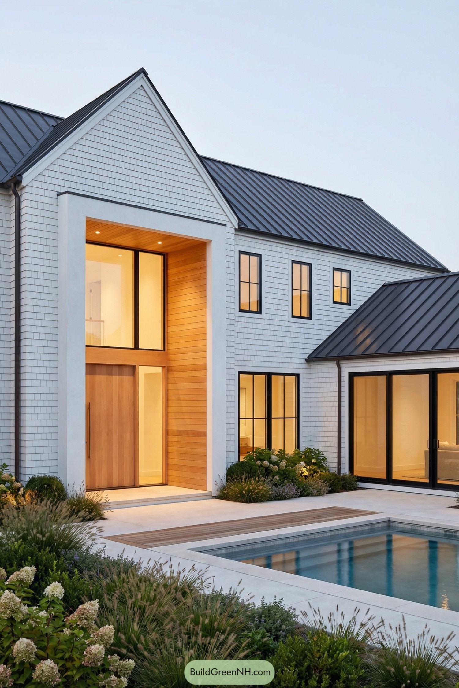 Modern Hamptons house with tall cedar entry and pool in landscaped courtyard