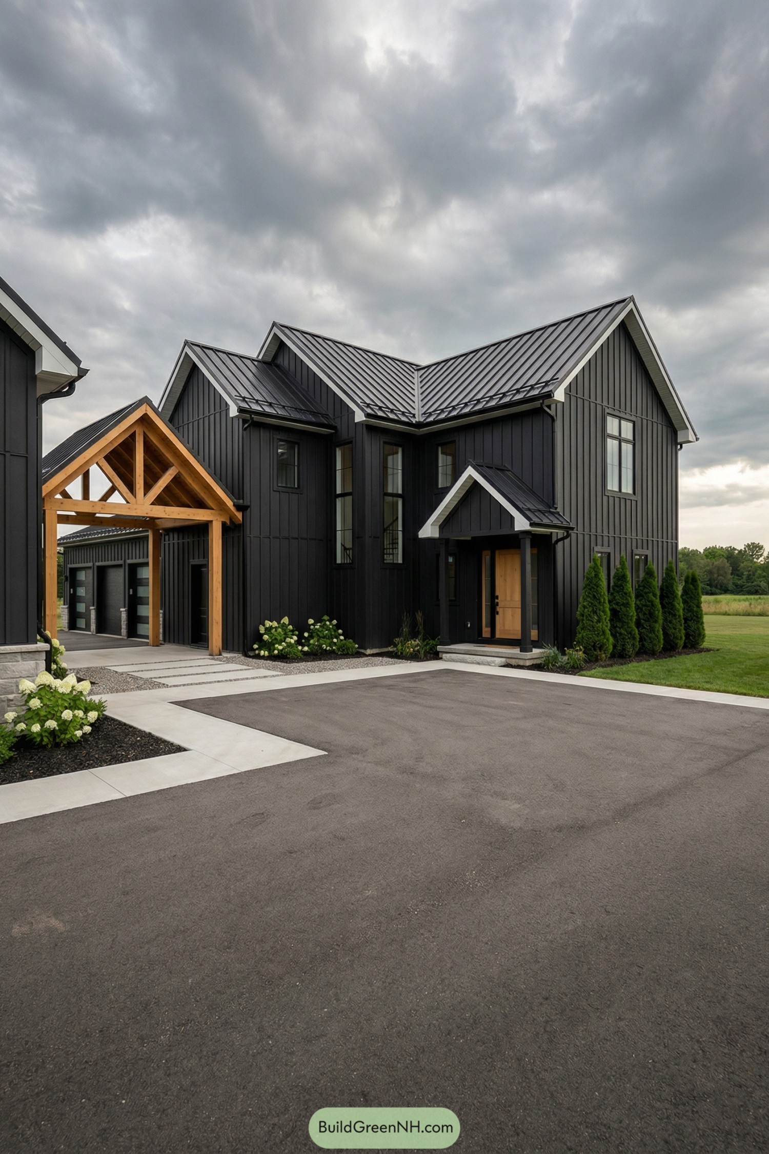 Modern black farmhouse with metal roof and timber breezeway connecting house to garage