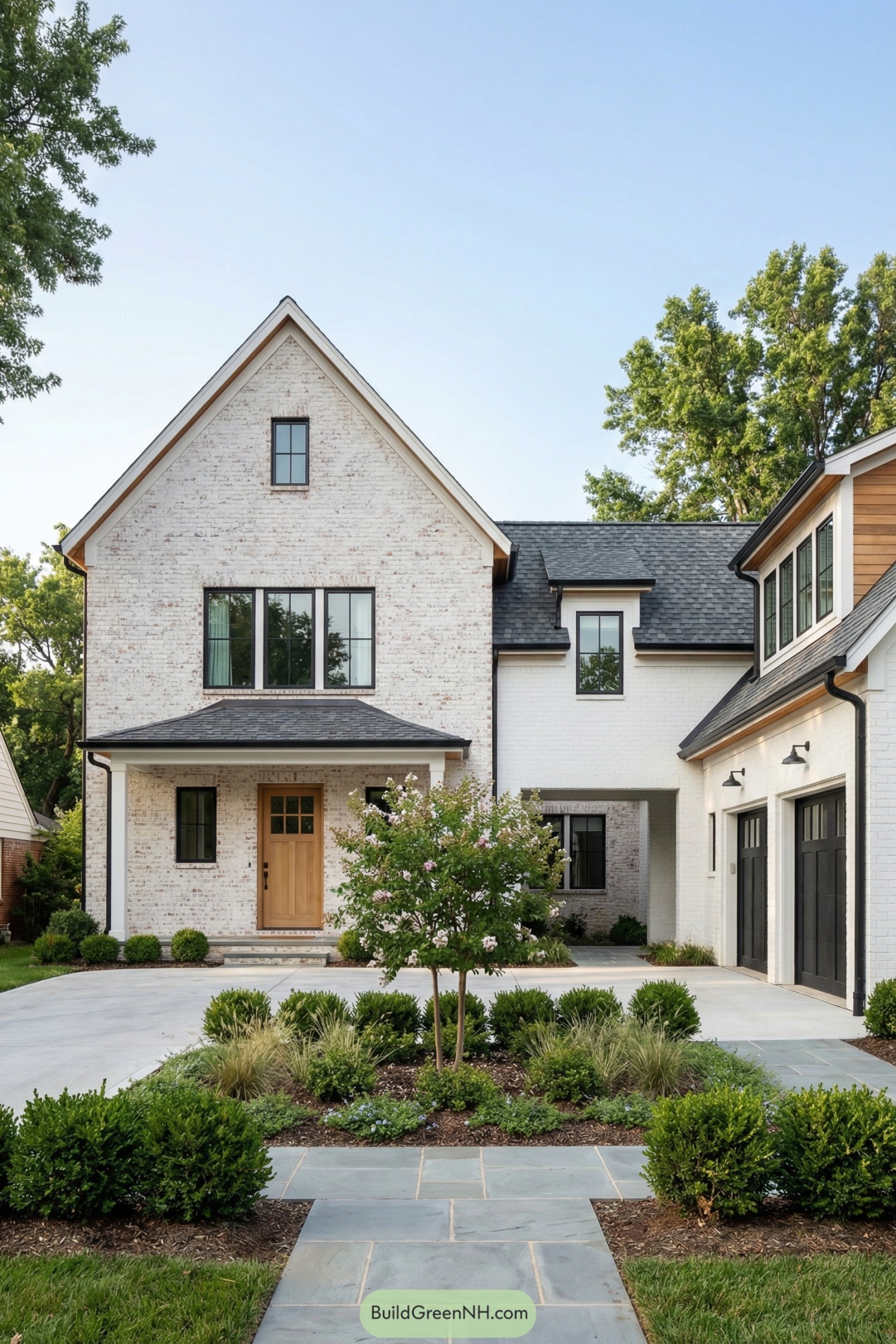 Modern white brick house with breezeway linking main residence and side garage, framed by simple landscaping and a small front tree