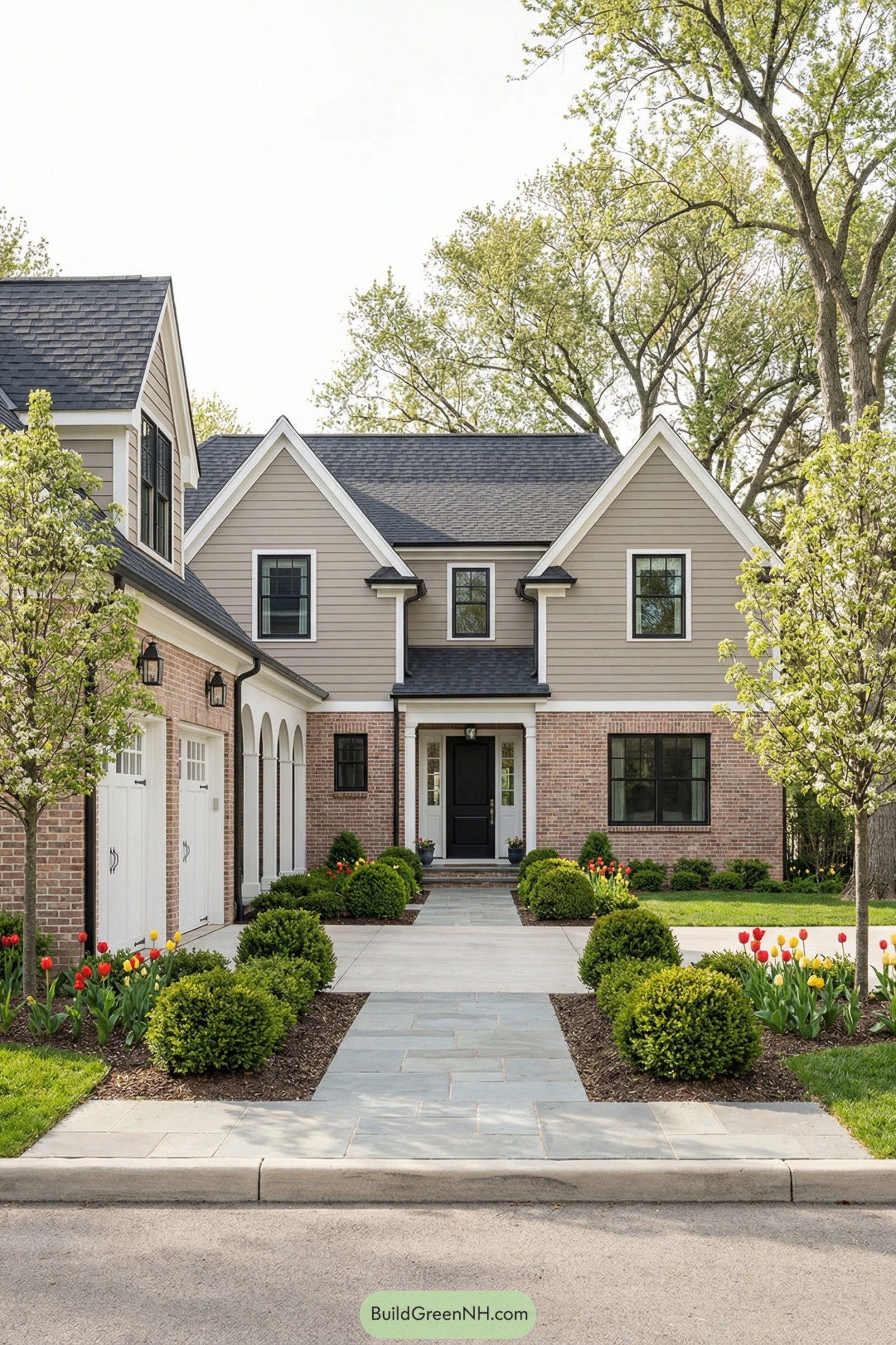 Charming two story home with arched breezeway linking main house and side garage, framed by formal front walk and lush landscaping