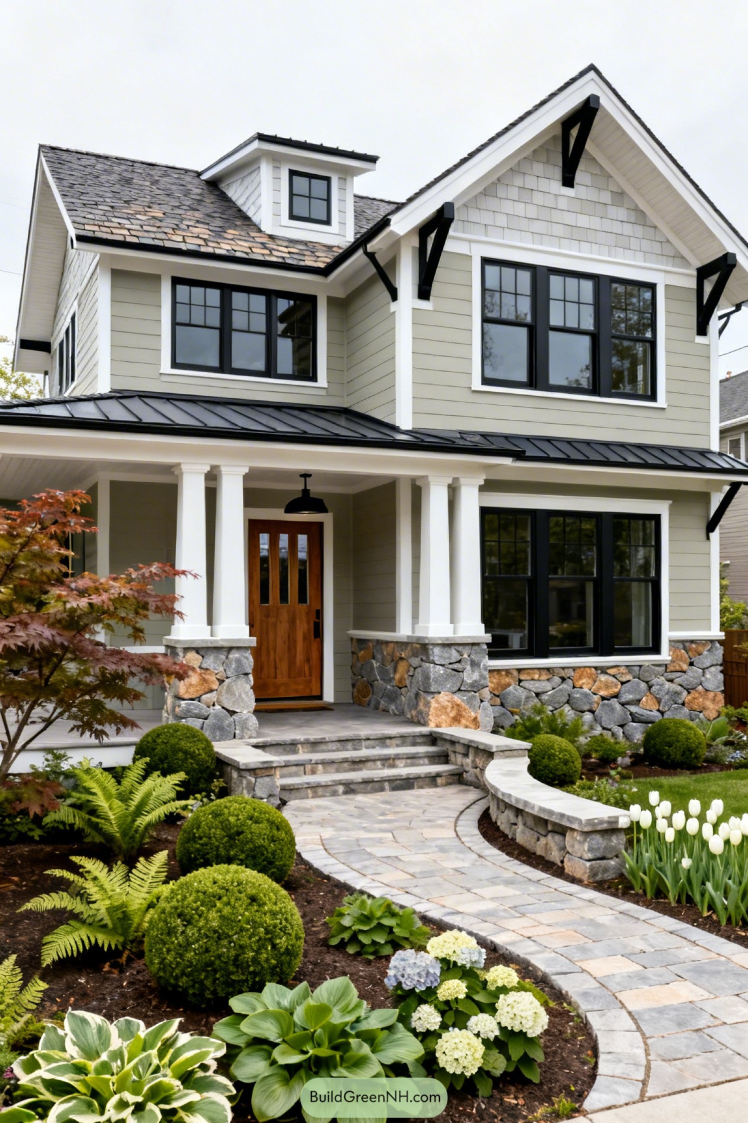 Modern cottage style house with stone base and lush garden path