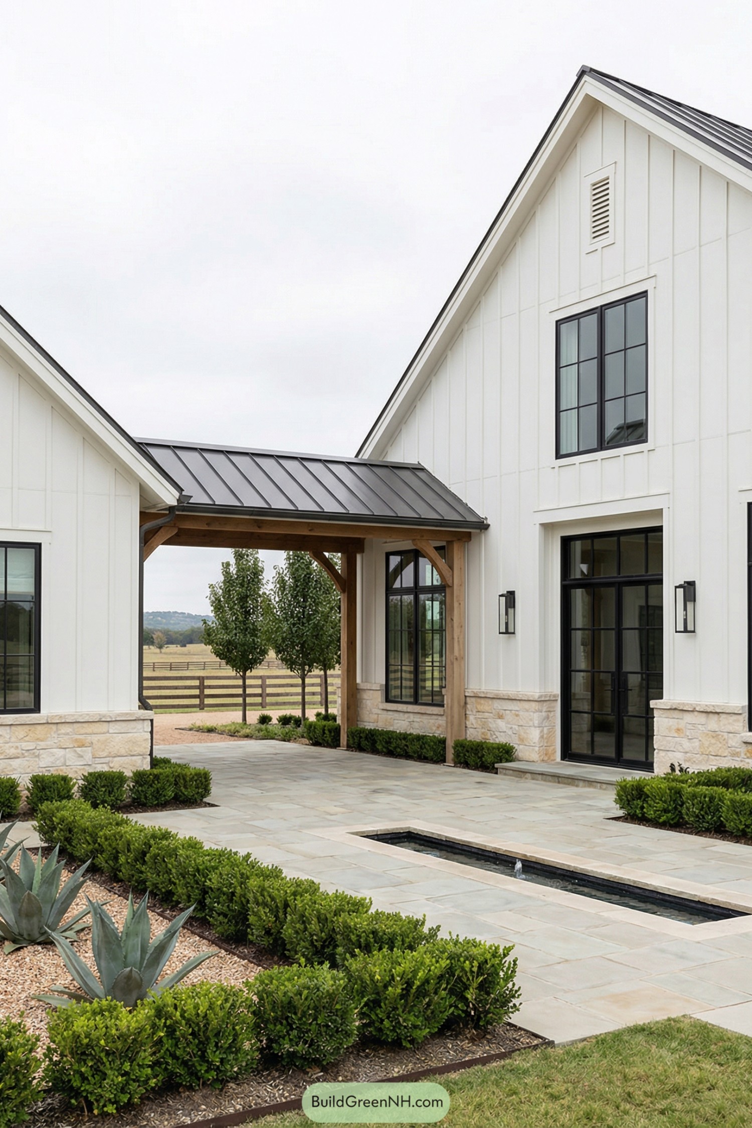 White board and batten farmhouse with metal roof breezeway and landscaped courtyard